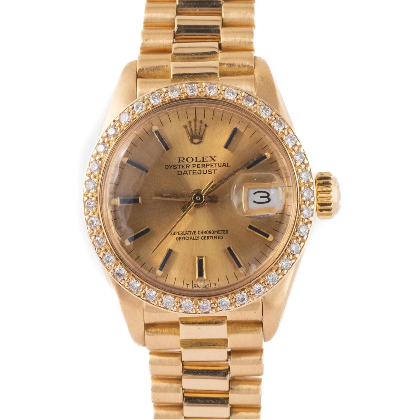 Rolex Lady-Datejust Oyster Bracelet 18K Yellow Gold Ladies Watch 6916. Automatic self-winding movement. 18K yellow gold oyster case 26.0 mm in diameter. Rolex logo on the crown. Diamond bezel. Champagne dial with Roman raised baton hour makers. Date
