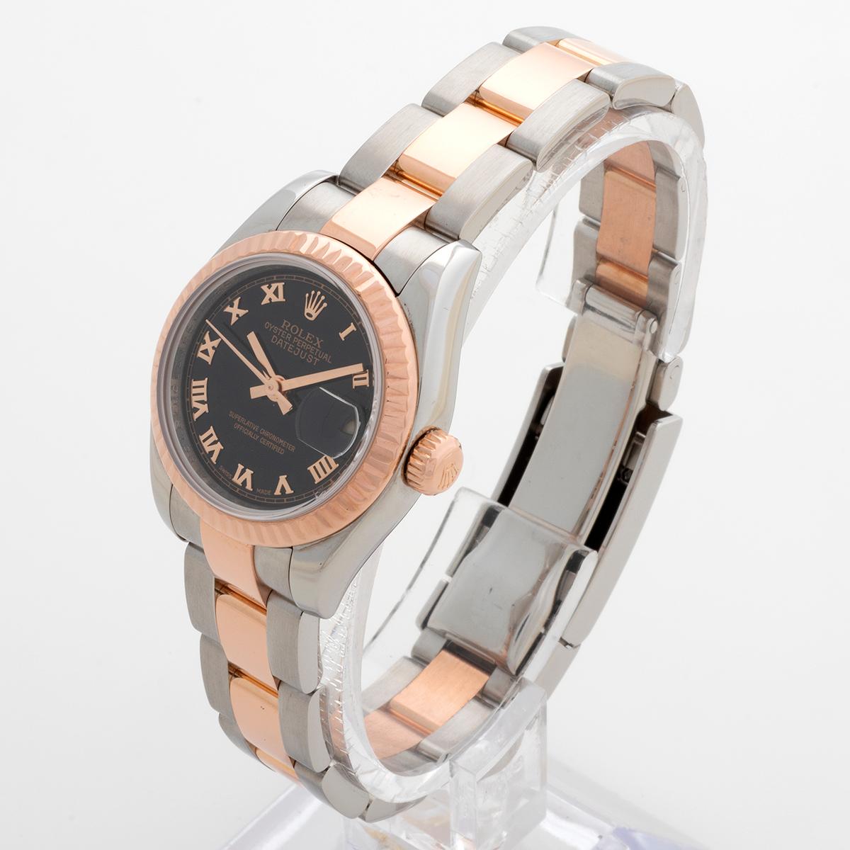 Our unusual and very attractive Rolex Lady Datejust reference 179171 features a 18k rose gold (everose) and stainless steel case with fluted bezel and Oyster bracelet and black Roman Numeral dial. Presented in outstanding condition, we date this
