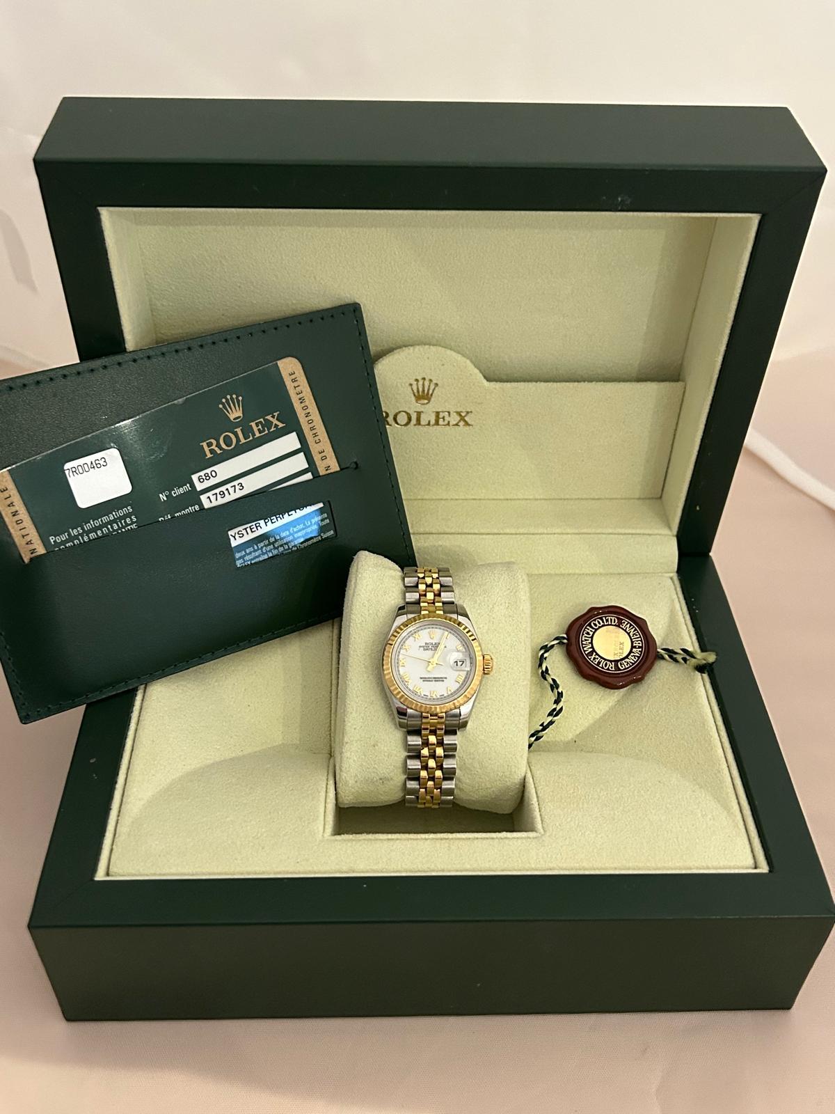 Our classic Rolex lady Datejust, reference 179173, with 26mm stainless steel case, fluted 18k yellow gold bezel and stainless steel/ 18k yellow gold jubilee bracelet with concealed clasp, features an attractive and relatively rare white Roman
