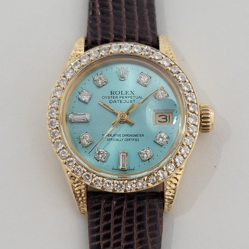 Dazzling luxury, 18k gold and diamond set Rolex Lady Datejust automatic, c.1981, in excellent working condition. Verified authentic by a master watchmaker. Gorgeous Rolex blue dial with luxurious aftermarket diamond hour markers, gilt minute and