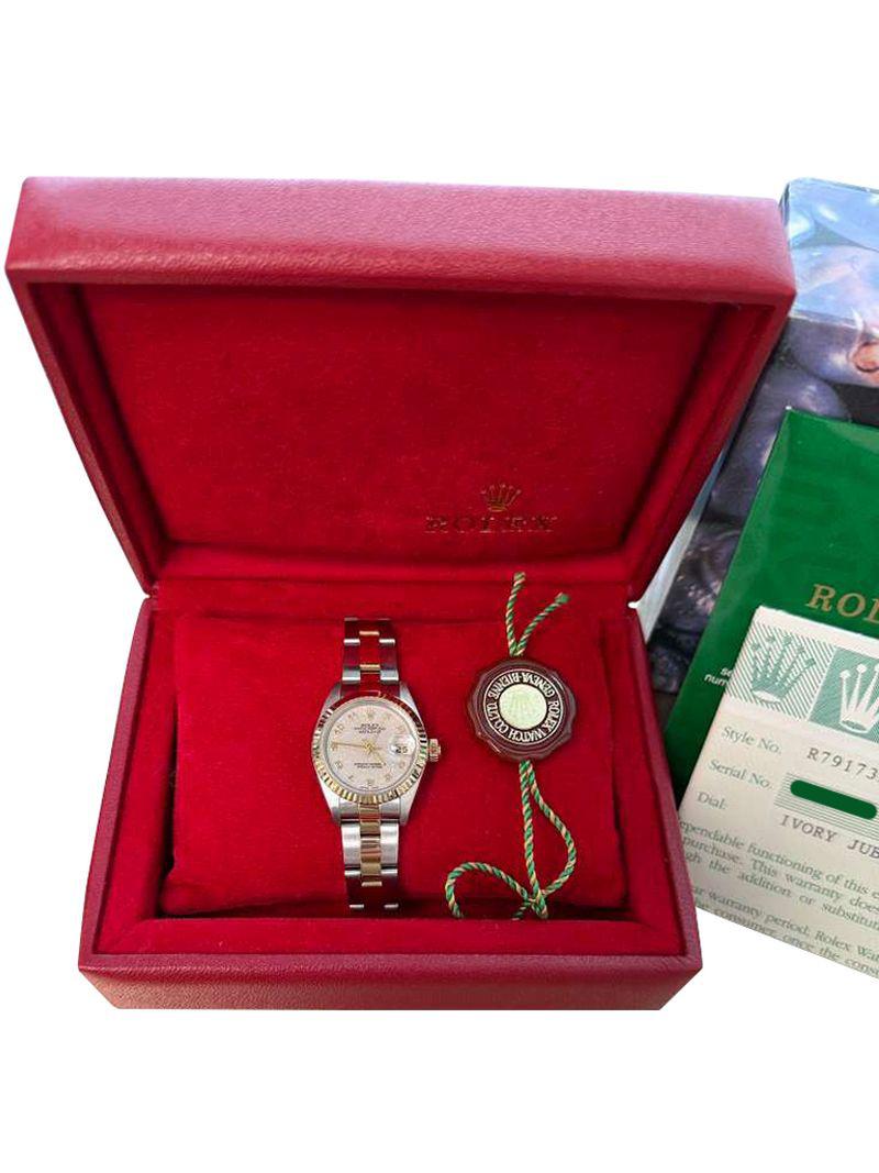 Rolex Lady-Datejust Steel Yellow Gold Ivory Dial Watch 79173. Officially certified chronometer self-winding movement. Stainless steel oyster case 26 mm in diameter. Rolex logo on an 18k yellow gold crown. 18k yellow gold fluted bezel.