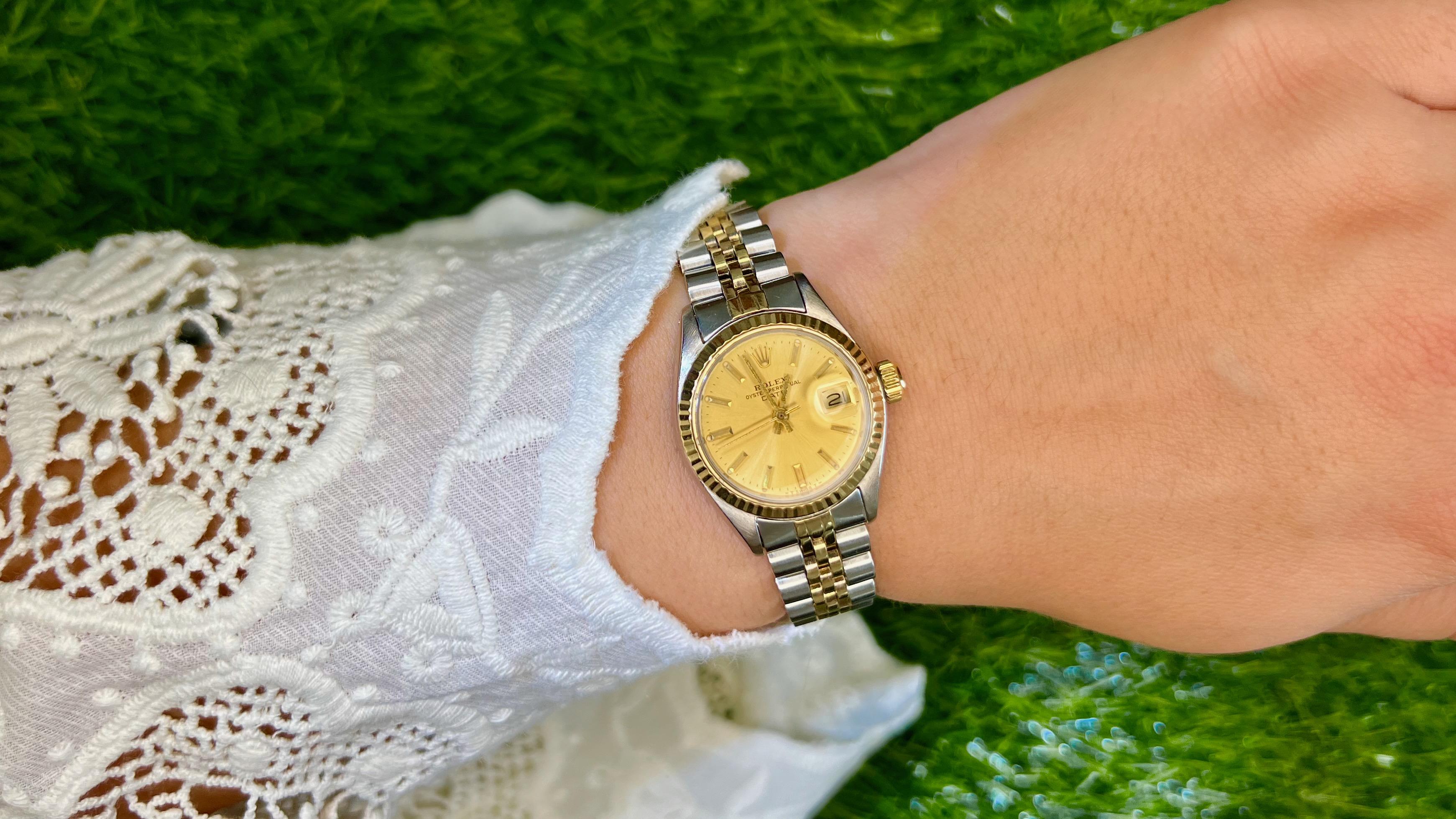 This is an authentic ROLEX Stainless Steel 18K Yellow Gold 28mm Oyster Perpetual Lady-Datejust Watch. Crafted from stainless steel and 18K yellow gold, this Rolex features an automatic movement with a date complication, gold dial, fluted bezel, and
