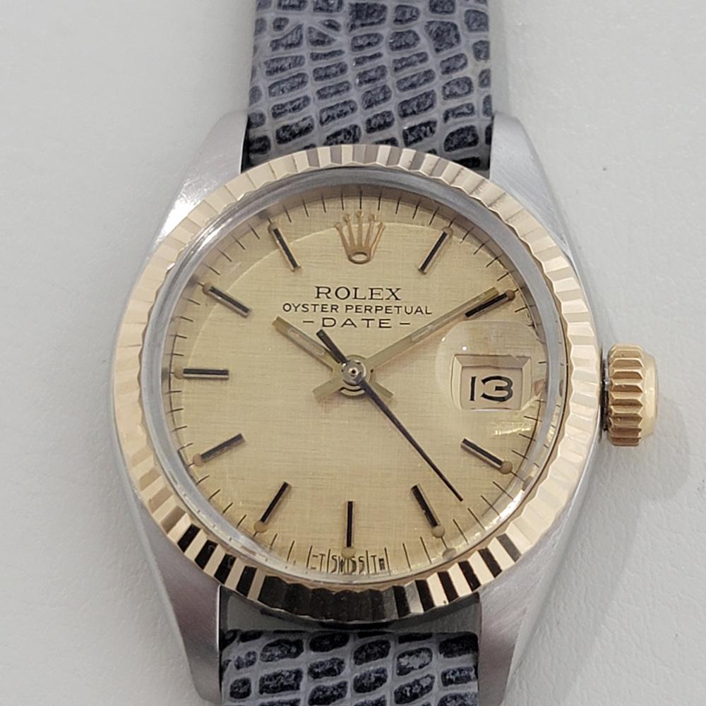 Luxurious classic, Rolex 18k gold and stainless steel Lady Oyster Perpetual Date automatic, c.1983, in excellent aesthetic and working condition. Verified authentic by a master watchmaker. Gorgeous Rolex linen dial with applied baton indice hour