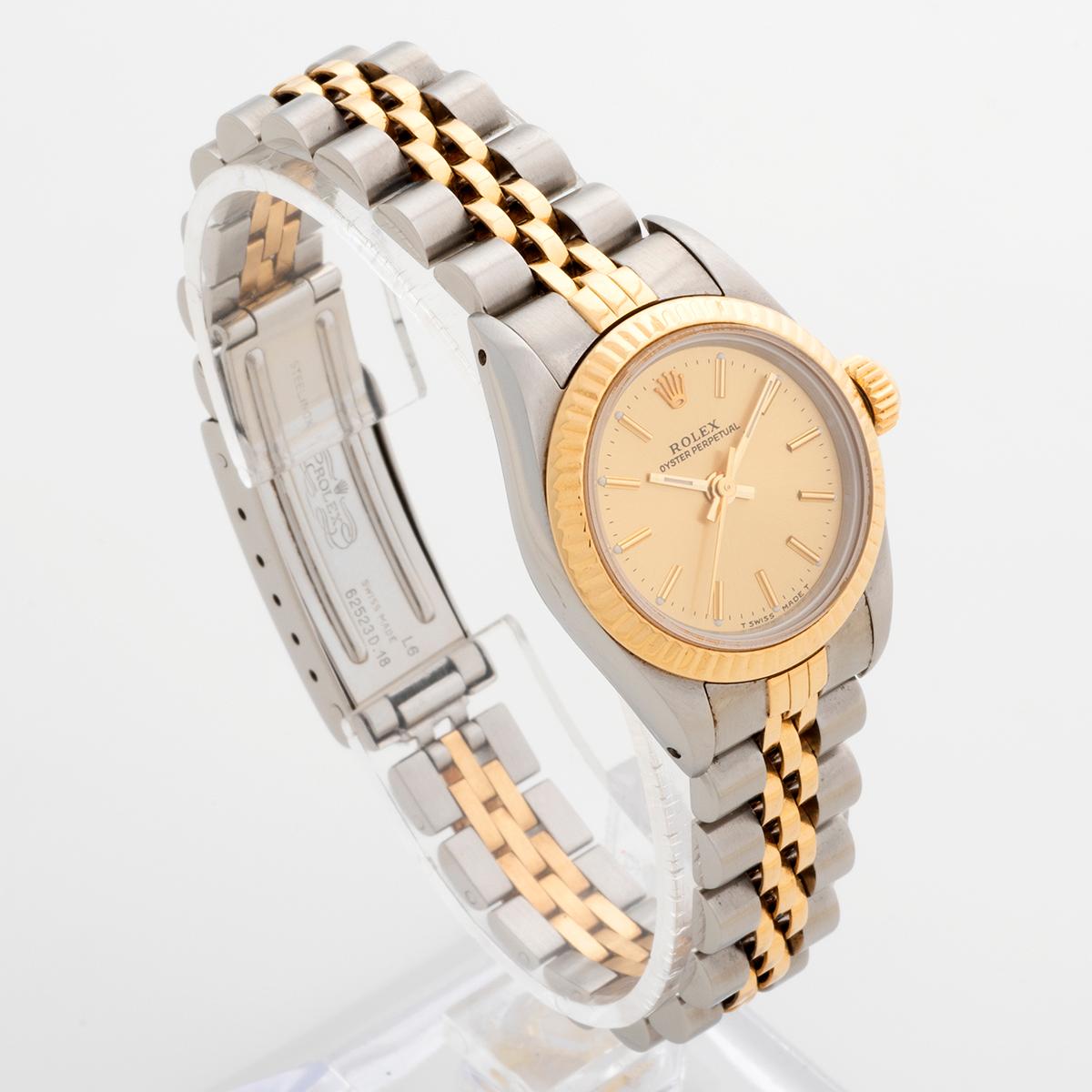 Our very attractive Rolex Lady Oyster Perpetual, reference 67193, features a 26mm stainless steel case with 18k yellow gold bezel , champagne dial and stainless steel and 18k yellow gold jubilee bracelet. Presented in excellent condition , this is