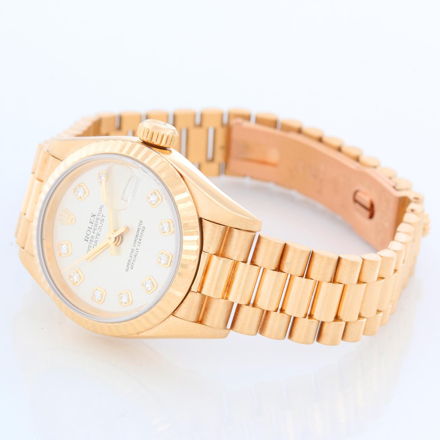 Rolex Lady President 18k Yellow Gold Ladies Watch 79178 - Automatic winding, 31 jewels, Quickset date, sapphire crystal. 18k yellow gold case(26mm diameter). Silver dial with factory diamond hour markers. 18k yellow gold Rolex hidden-clasp President