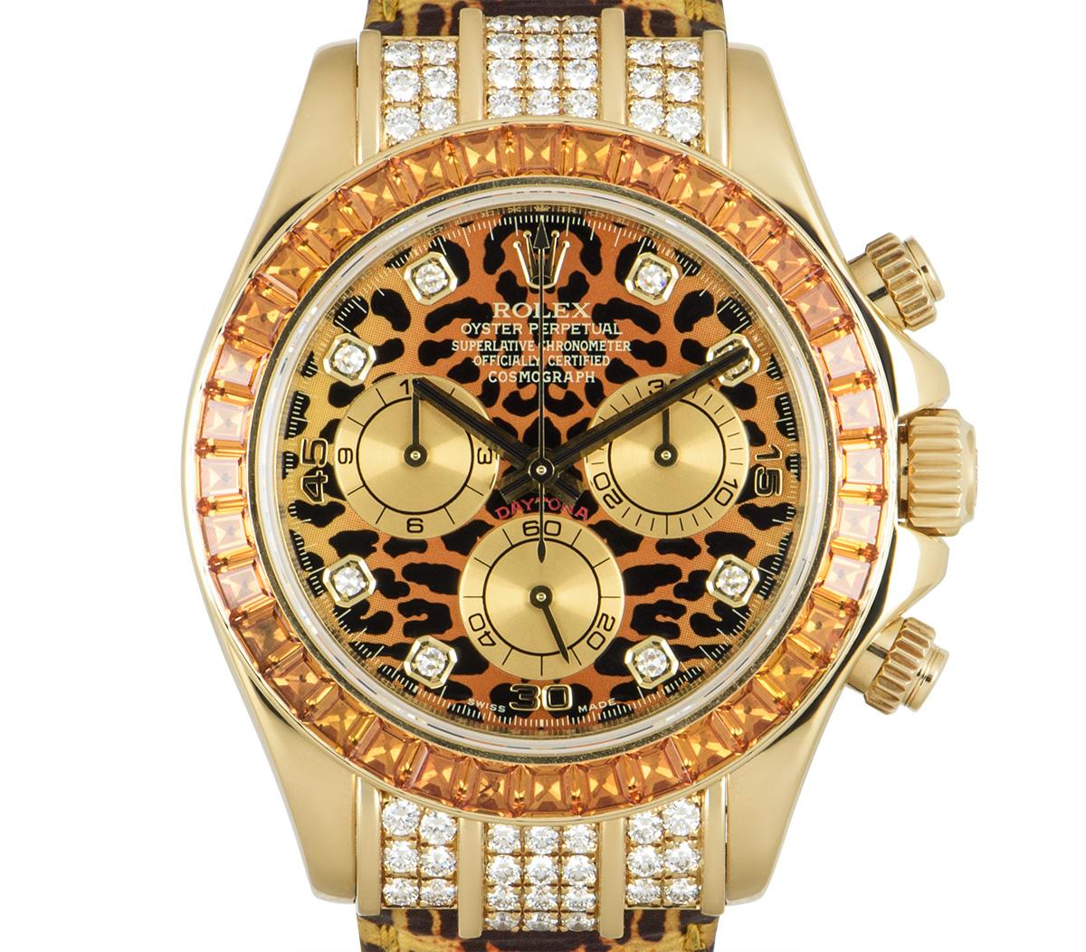 This 40 mm Daytona in yellow gold by Rolex, nicknamed leopard was introduced in Basel in 2004. Featuring a leopard print dial set with 8 round brilliant cut diamond hour markers and the bezel set with 36 baguette cut cognac sapphires. The lugs are
