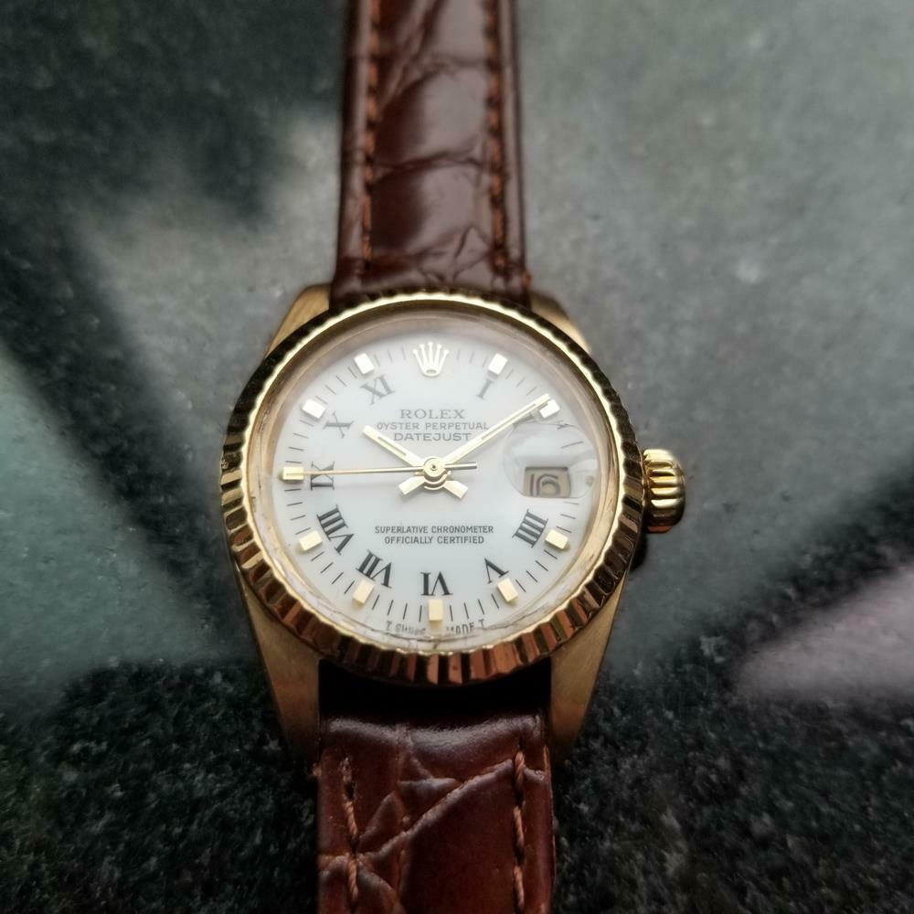 Timeless luxury, 18k solid gold Rolex Ladies Oyster Perpetual Datejust 6917 automatic, c.1982. Verified authentic by a master watchmaker. Gorgeous white Rolex dial, applied gold indice and black Roman numeral hour markers, gilt minute and hour