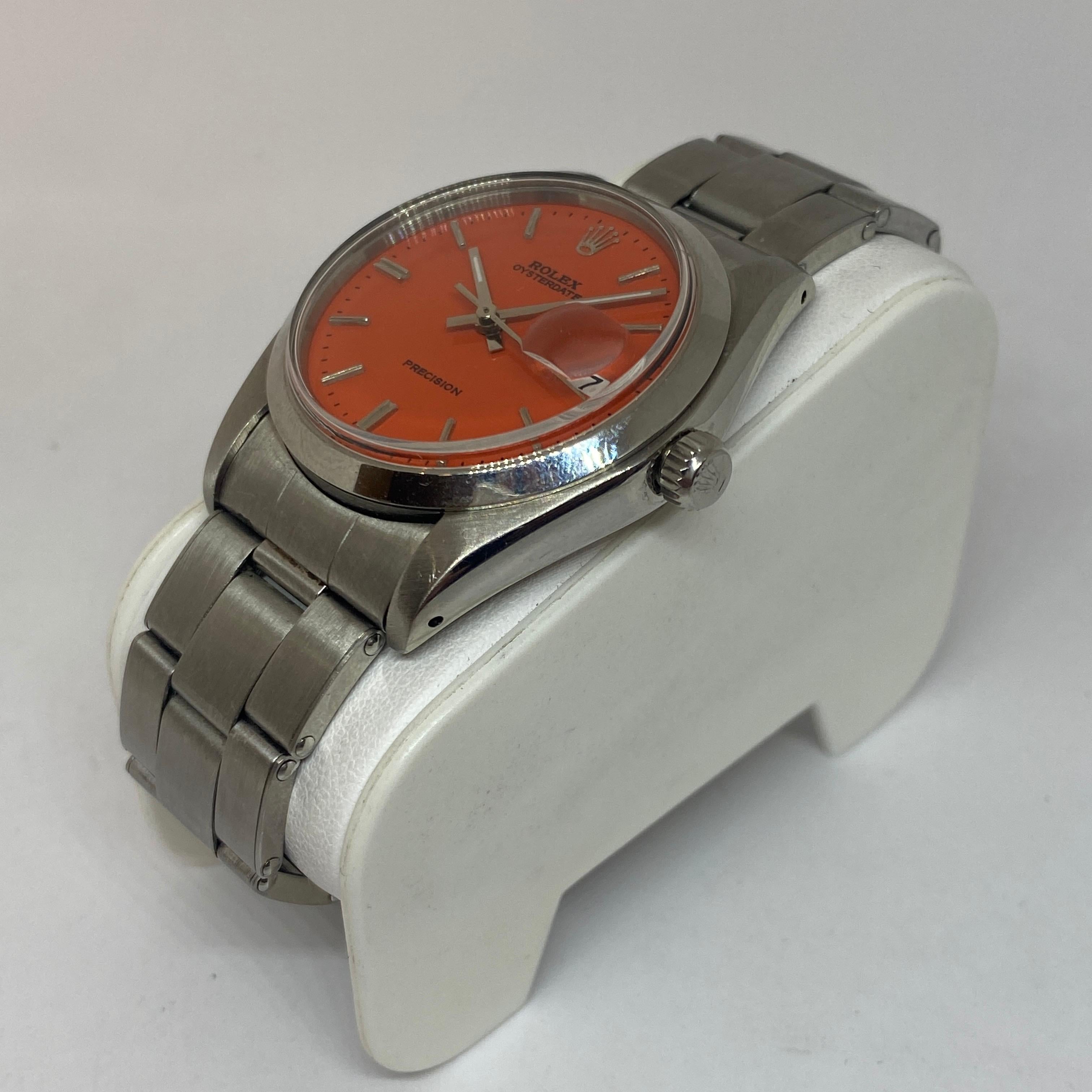 Pre-owned Rolex Oysterdate Precision timepiece designed in stainless steel, 35mm with an orange SR dial, oyster link bracelet, automatic movement and one year warranty included. The watch measures 8