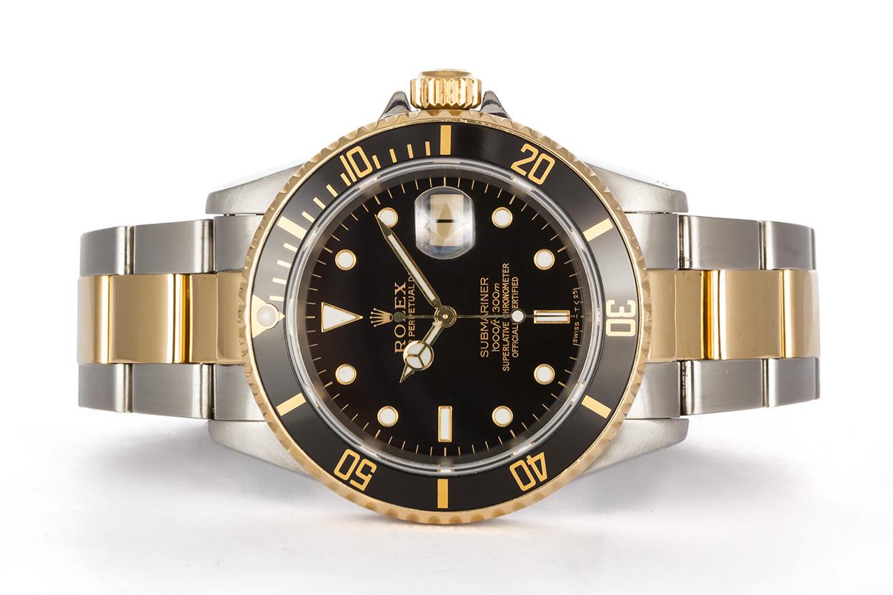 We are pleased to offer this 1997 Rolex Mens Two Tone Submariner 16613. It features a 40mm stainless steel case with black dial, 18k yellow gold bezel with black metal insert and 18k yellow gold polished center links. It will fit up to a 7