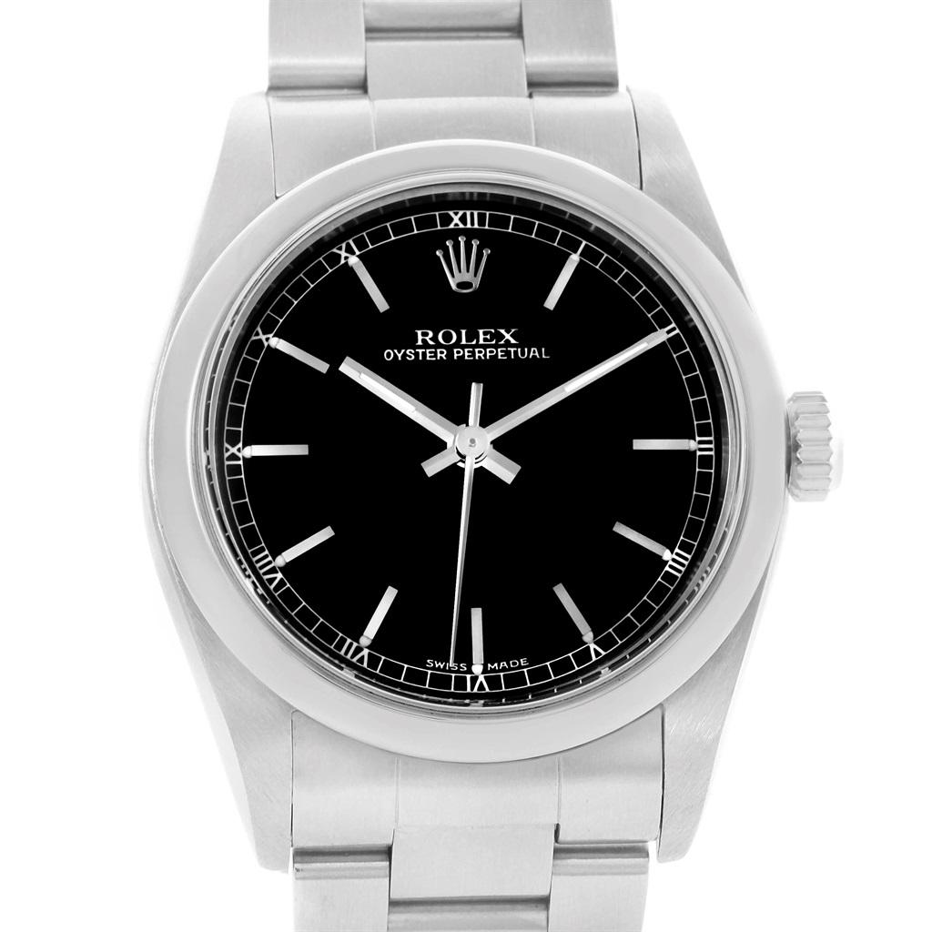 Rolex Midsize 31 Black Baton Dial Steel Ladies Watch 77080. Officially certified chronometer automatic self-winding movement. Stainless steel oyster case 31.0 mm in diameter. Rolex logo on a crown. Stainless steel smooth domed bezel. Scratch