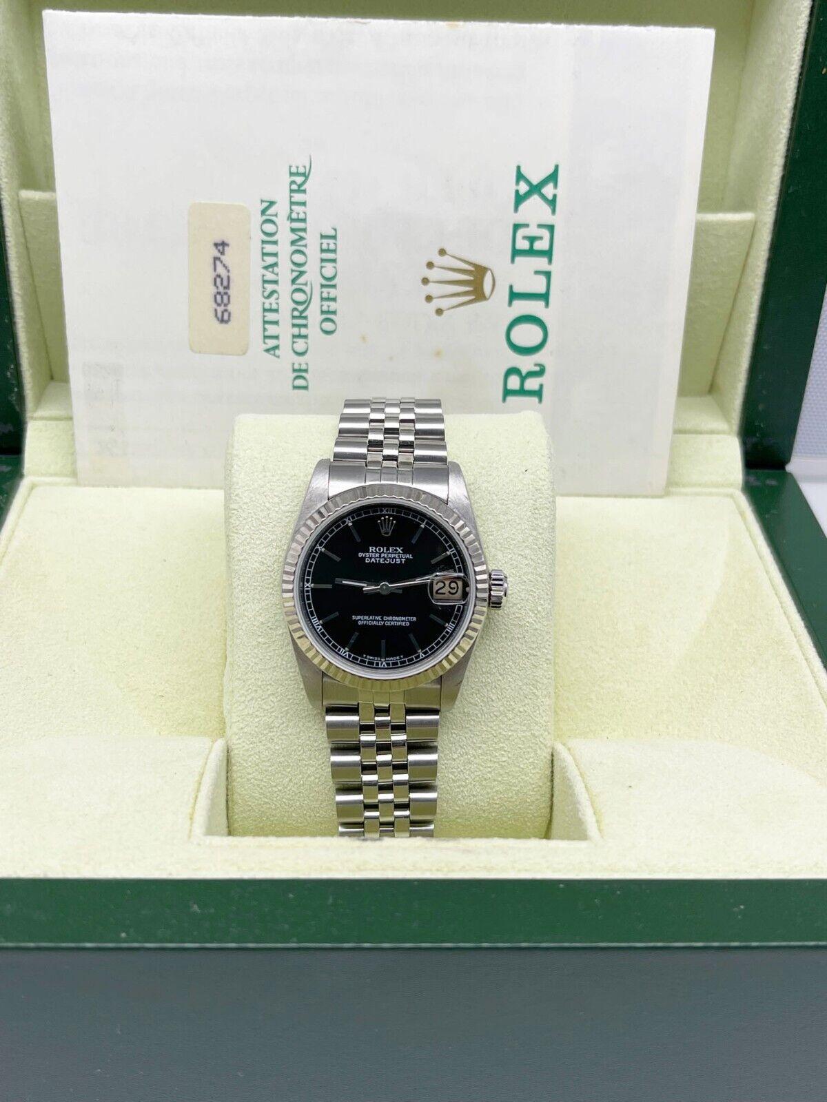 
Style Number: 68274

Serial: R785***

Model: Midsize Datejust

Case Material: Stainless Steel

Band: Stainless Steel

Bezel: 18K White Gold

Dial: Black 

Face: Sapphire Crystal

Case Size: 31mm 

Includes: 

-Rolex Box, Paper, and