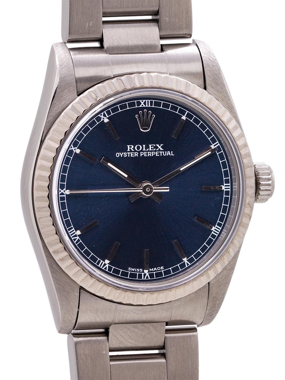
Rolex midsize Oyster Perpetual ref 67514, circa 1995 featuring a 31mm diameter Oyster case with 18K white gold fluted bezel and sapphire crystal. With popular original blue dial with applied stick indexes and silver baton hands. Powered by self
