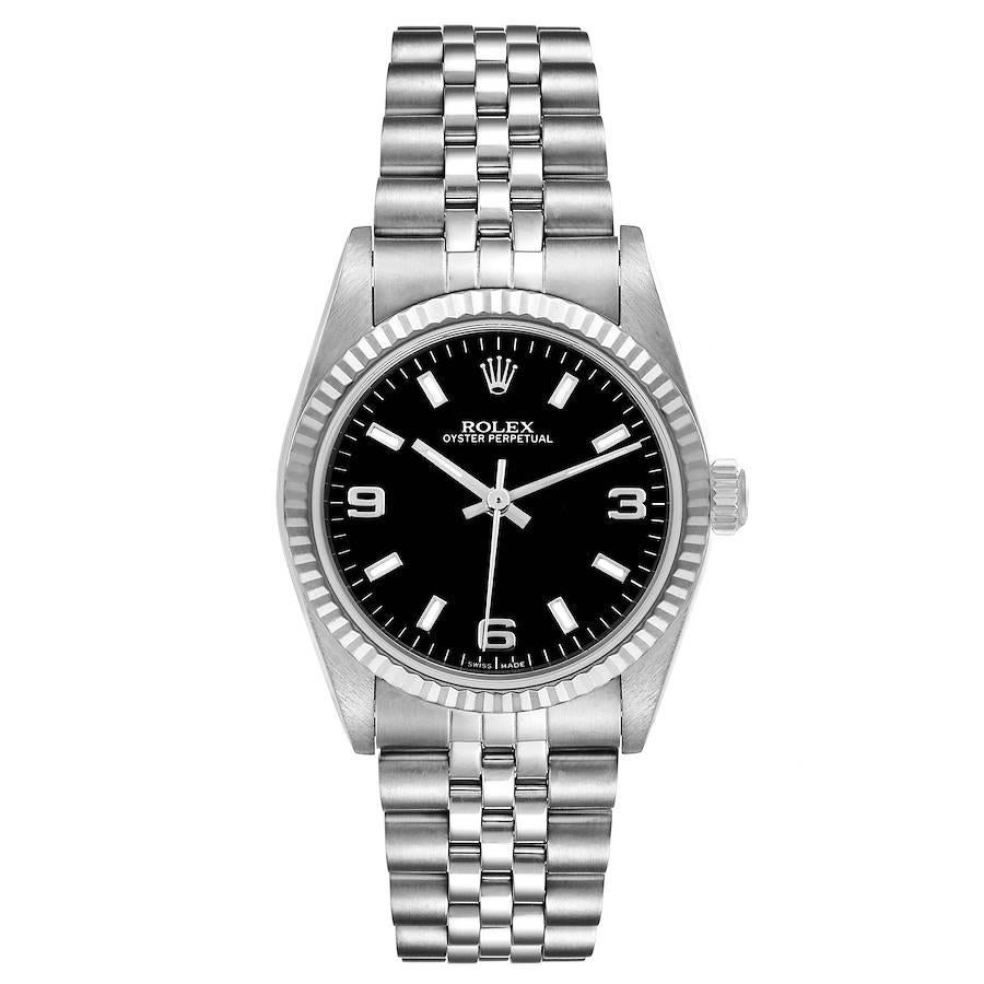 Rolex Midsize Steel White Gold Black Dial Ladies Watch 77014 Box Papers. Officially certified chronometer self-winding movement. Stainless steel oyster case 31.0 mm in diameter. Rolex logo on a crown. 18K white gold fluted bezel. Scratch resistant
