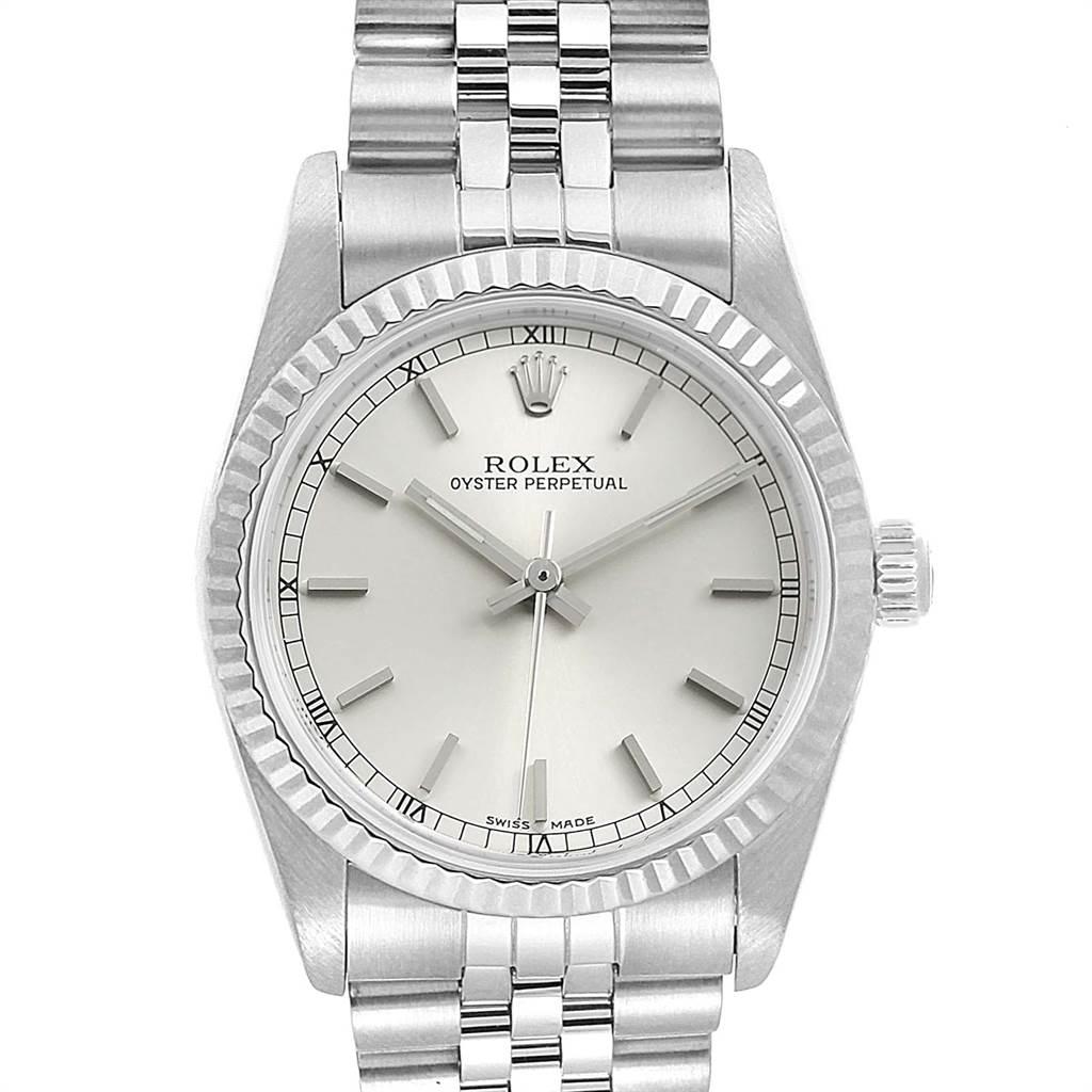 Rolex Midsize Steel White Gold Silver Dial Ladies Watch 77014. Officially certified chronometer self-winding movement. Stainless steel oyster case 31.0 mm in diameter. Rolex logo on a crown. 18K white gold fluted bezel. Scratch resistant sapphire