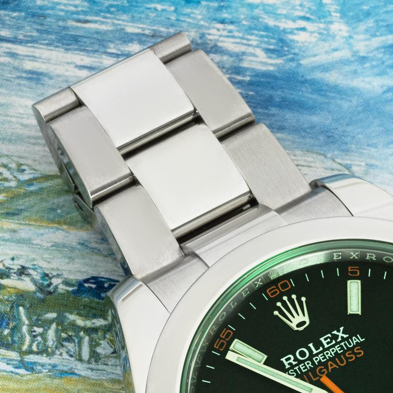A 40mm Milgauss in stainless steel by Rolex. Featuring a black dial with an orange second-hand shaped like a lightning bolt and a green sapphire crystal exclusive to the Milgauss design.

The watch is equipped with an Oyster bracelet set with an