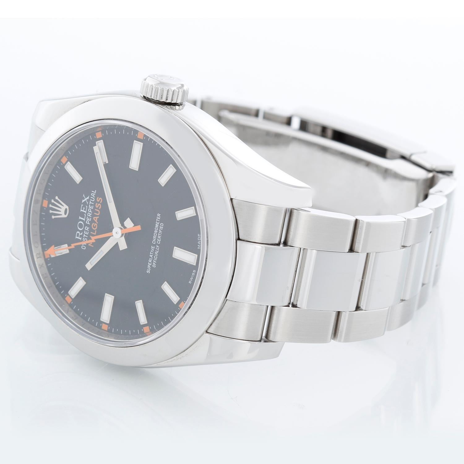 Rolex Milgauss Stainless Steel Men's Watch Black Dial 116400 - Automatic winding, sapphire crystal, 31 jewels. Stainless steel case with smooth bezel (40mm diameter). Black dial with luminous-style orange markers. Stainless steel Oyster bracelet