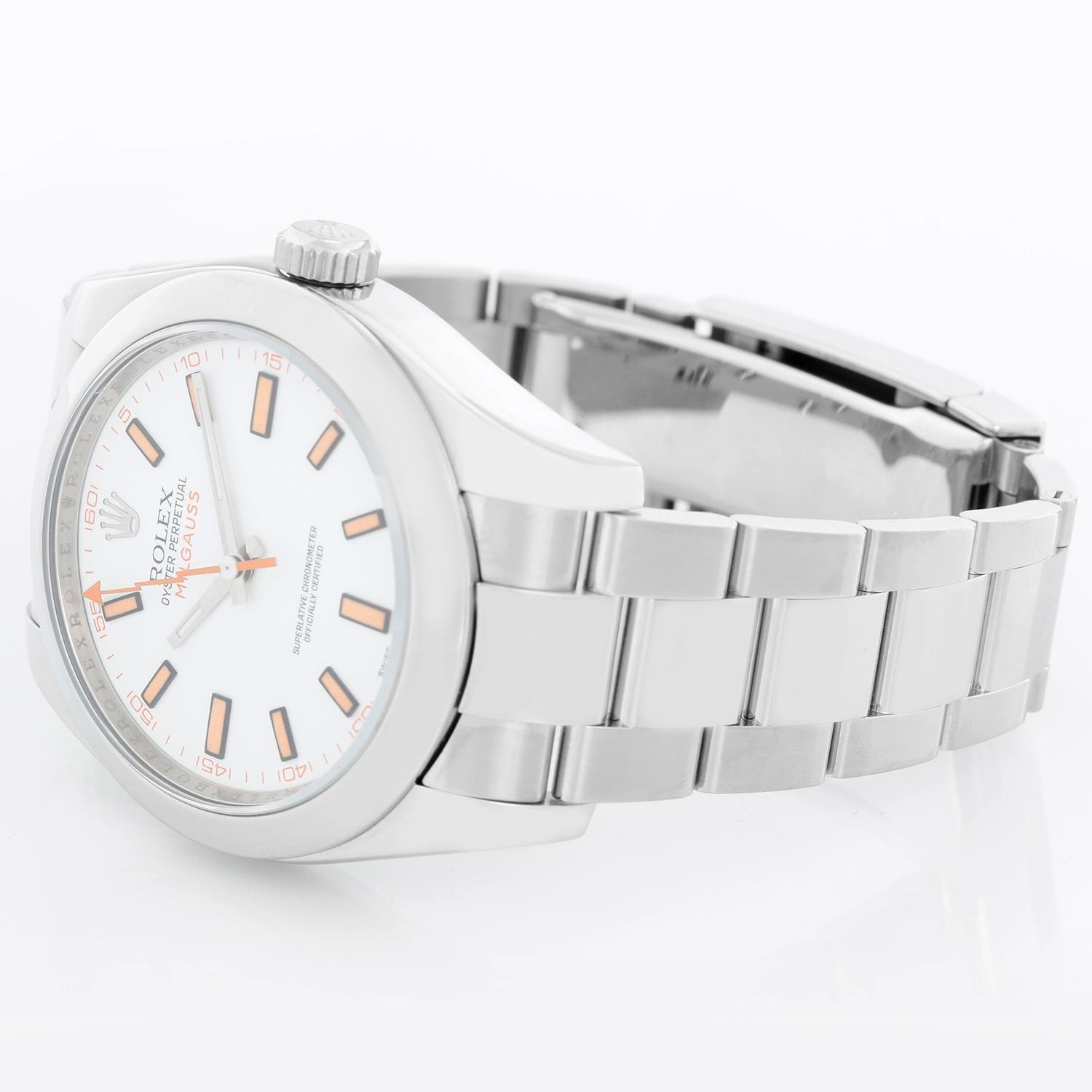 Rolex Milgauss Stainless Steel Men's Watch White Dial 116400 - Automatic winding, sapphire crystal, 31 jewels. Stainless steel case with smooth bezel (40mm diameter). White dial with luminous-style orange markers. Stainless steel Oyster bracelet
