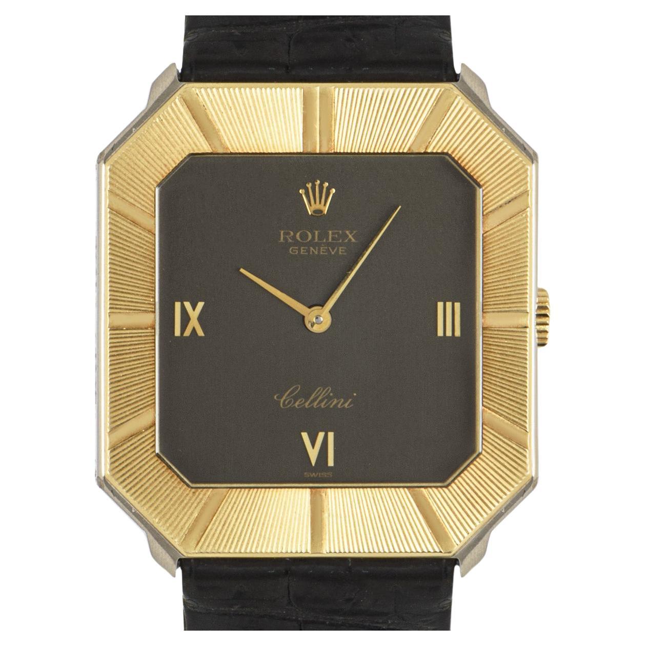 A stunning Cellini two-tone wristwatch in yellow gold and white gold by Rolex. Features a black dial with applied roman numerals, a fixed yellow gold bezel and a white gold case back. The watch is encased with a sapphire glass and powered by a
