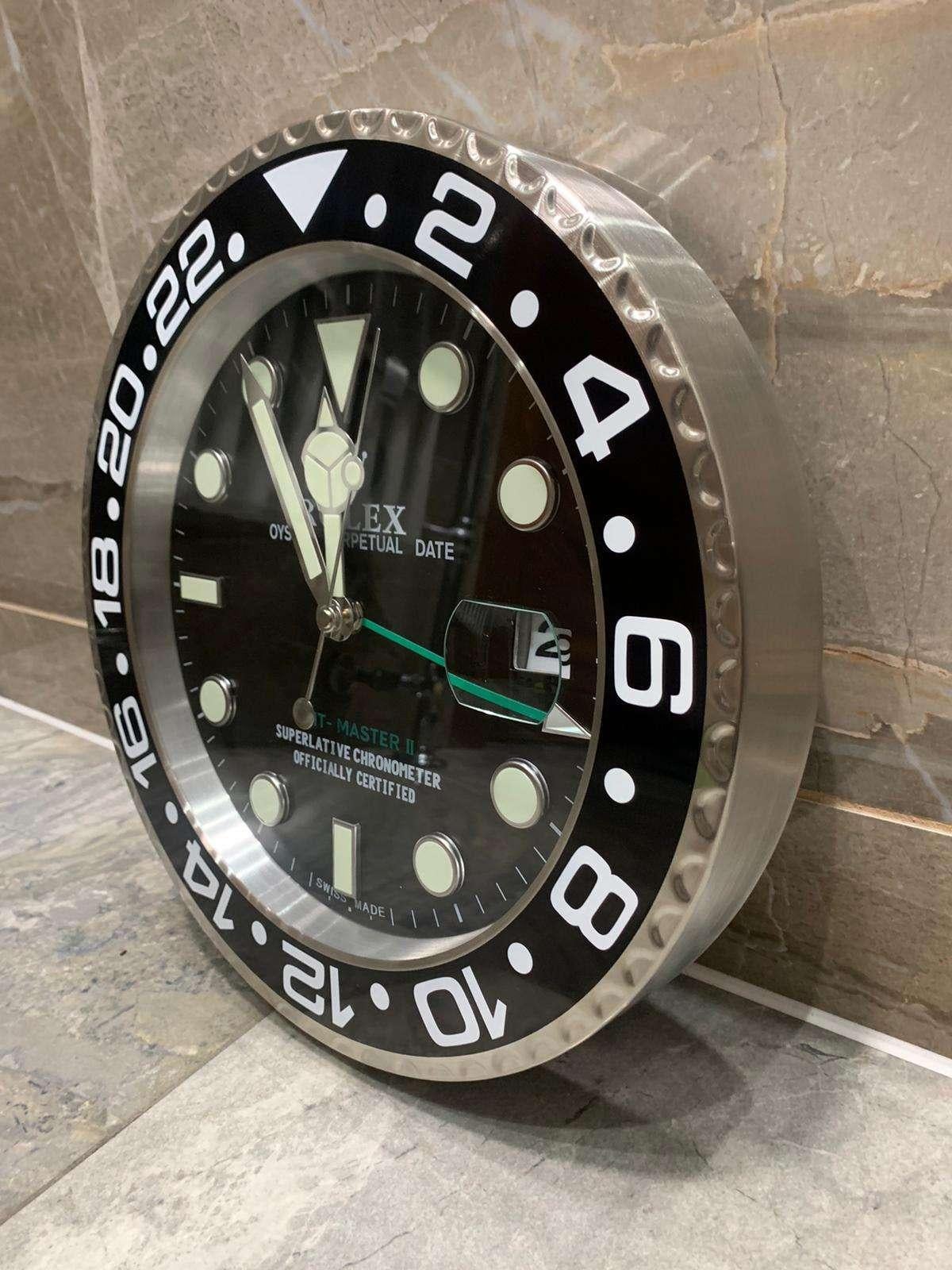 ROLEX Officially Certified Oyster Perpetual Black GMT Master II Wall Clock 
Good condition, working.
Free international shipping.
Luminous Hands
Date fully functional
Sweeping hand (not ticking)
Quartz Movement (requires 2x AA battery)