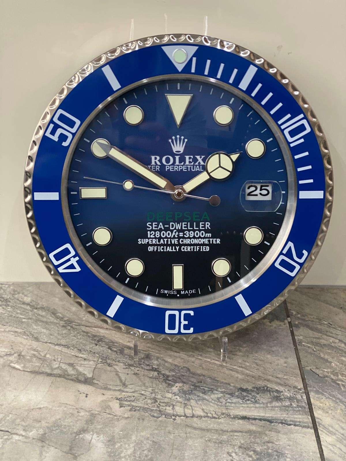 ROLEX Officially Certified Oyster Perpetual Blue Deepsea Sea Dweller Wall Clock 
Good condition, working.
Lume strips Sweeping Quartz movement powered by single AA Battery.
Clock dimensions measure approximately 35cm by 5cm thickness
Free