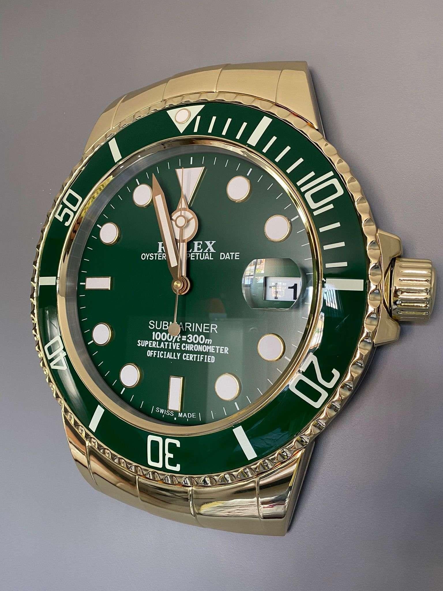 ROLEX Officially Certified Oyster Perpetual Date Green and stainless steel Chrome Gold Submariner Wall Clock 

With lume strips Sweeping Quartz movement powered by single AA Battery.
Clock dimensions measure approximately 43cm by 7cm thickness Date