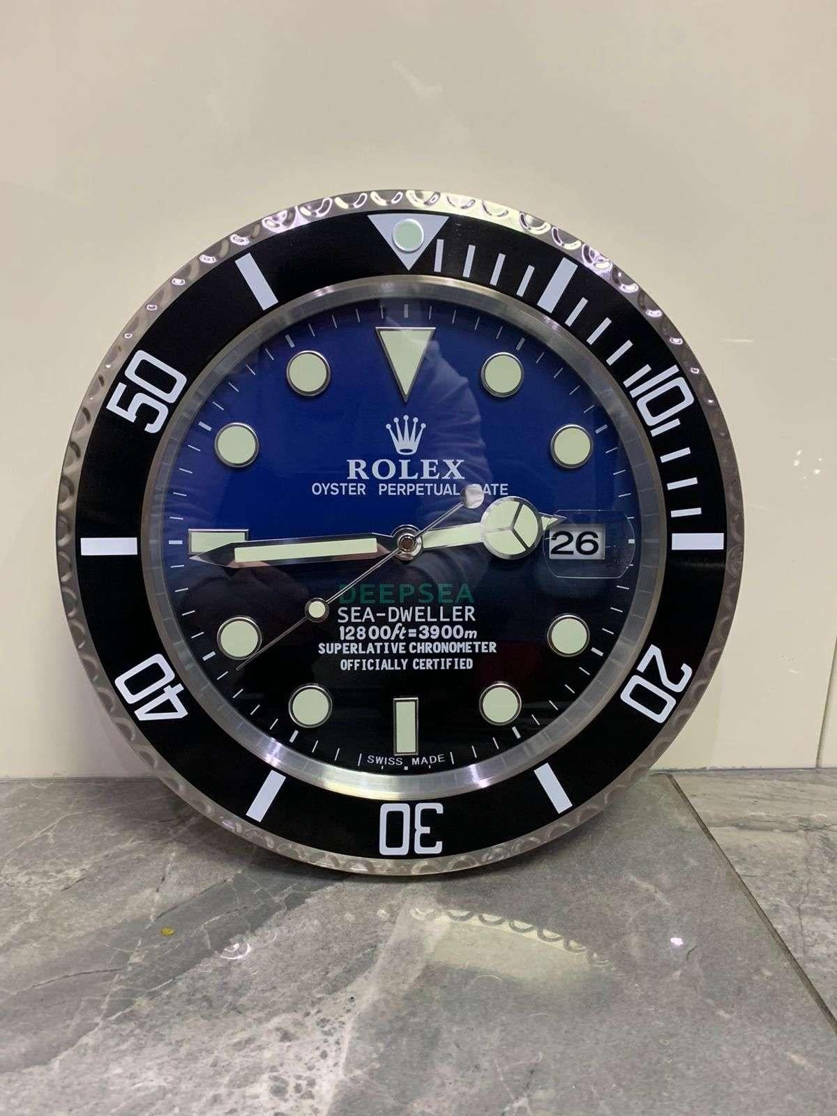 ROLEX Officially Certified Oyster Perpetual Deepsea Dweller Wall Clock 
Good condition, working.
Free international shipping.
With lume strips Sweeping Quartz movement powered by single AA Battery.
Clock dimensions measure approximately 35cm by 5cm