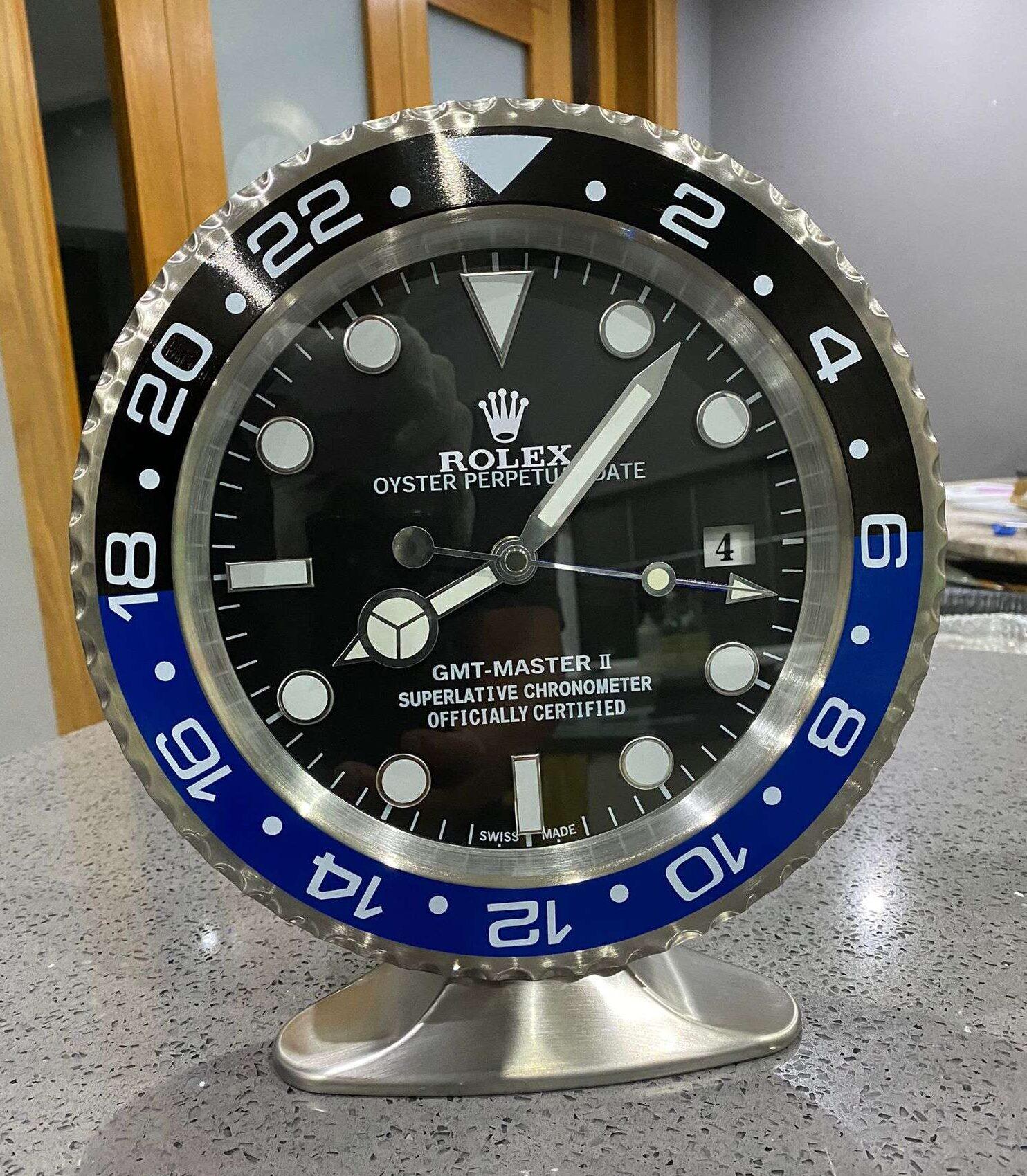 ROLEX Officially Certified Oyster Perpetual GMT Master II BATMAN Desk Clock 

Luminous hands.
Fully functional date.
Sweeping hands.
Quartz movement.
Good condition, working.
Free international shipping.

These wall clocks are officially licensed by
