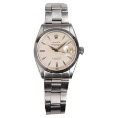 Reloj Rolex OP 6534 esfera blanca en caja de acero inoxidable, años 50