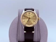 Rolex Oyster Perpetual 1002 34mm Champagne Dial Yellow Gold Steel Leather Strap