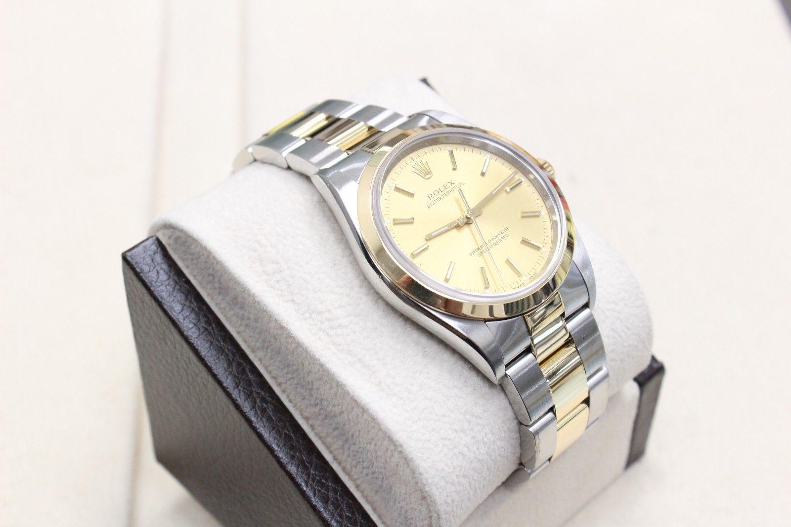 Style Number: 14203

Serial: Y300***

Model: OYSTER PERPETUAL

Case: 34mm 

Band: 18K Yellow Gold & Stainless Steel 

Bezel: 18K Yellow Gold 

Dial: Champagne 

Face: Sapphire Crystal 

Case Size: 34mm

Includes: 

- Rolex Box & Papers

-Certified