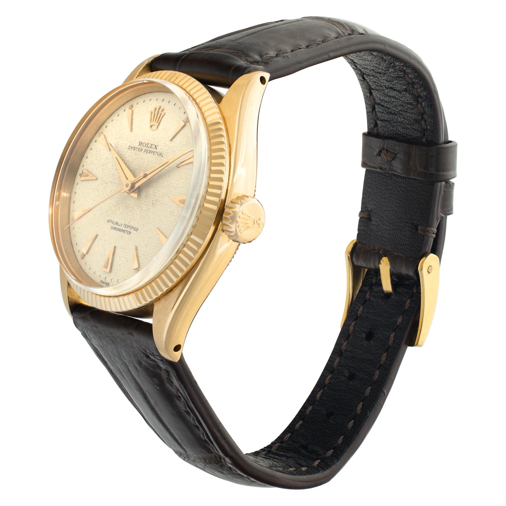 Vintage Rolex Oyster Perpetual in 18k rose gold with Honeycomb dial on a European leather strap with tang buckle. Auto w/ sweep seconds. 34 mm case size. Ref 6285. Circa 1954. Fine Pre-owned Rolex Watch.

 Certified preowned Vintage Rolex Oyster