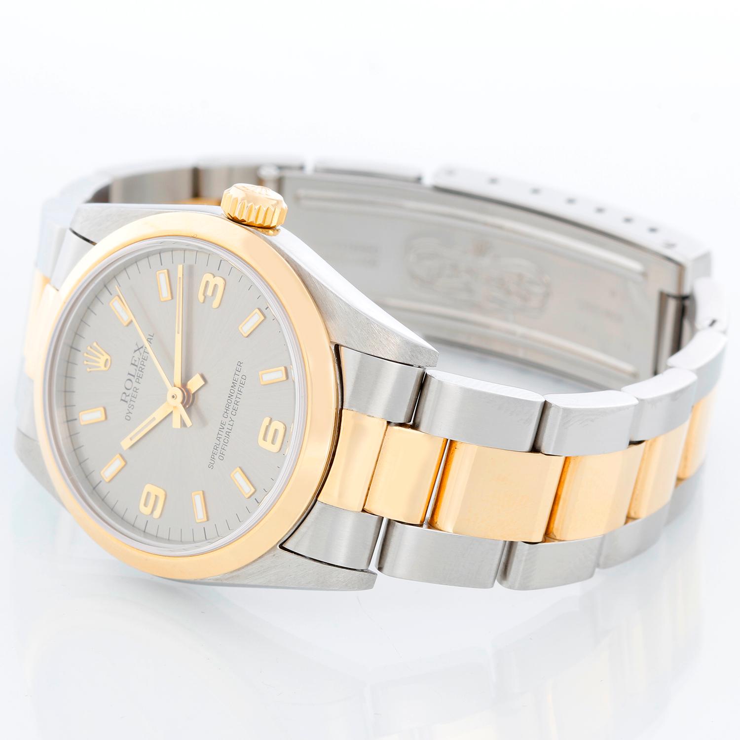 Rolex Oyster Perpetual 2-Tone 31 MM Mens Watch 67483 - Automatic winding, 29 jewels, Quickset date, sapphire crystal. Stainless steel case with yellow gold bezel ( 31mm) . Silver dial with roman numerals and stick hour markers. 18K Yellow gold and