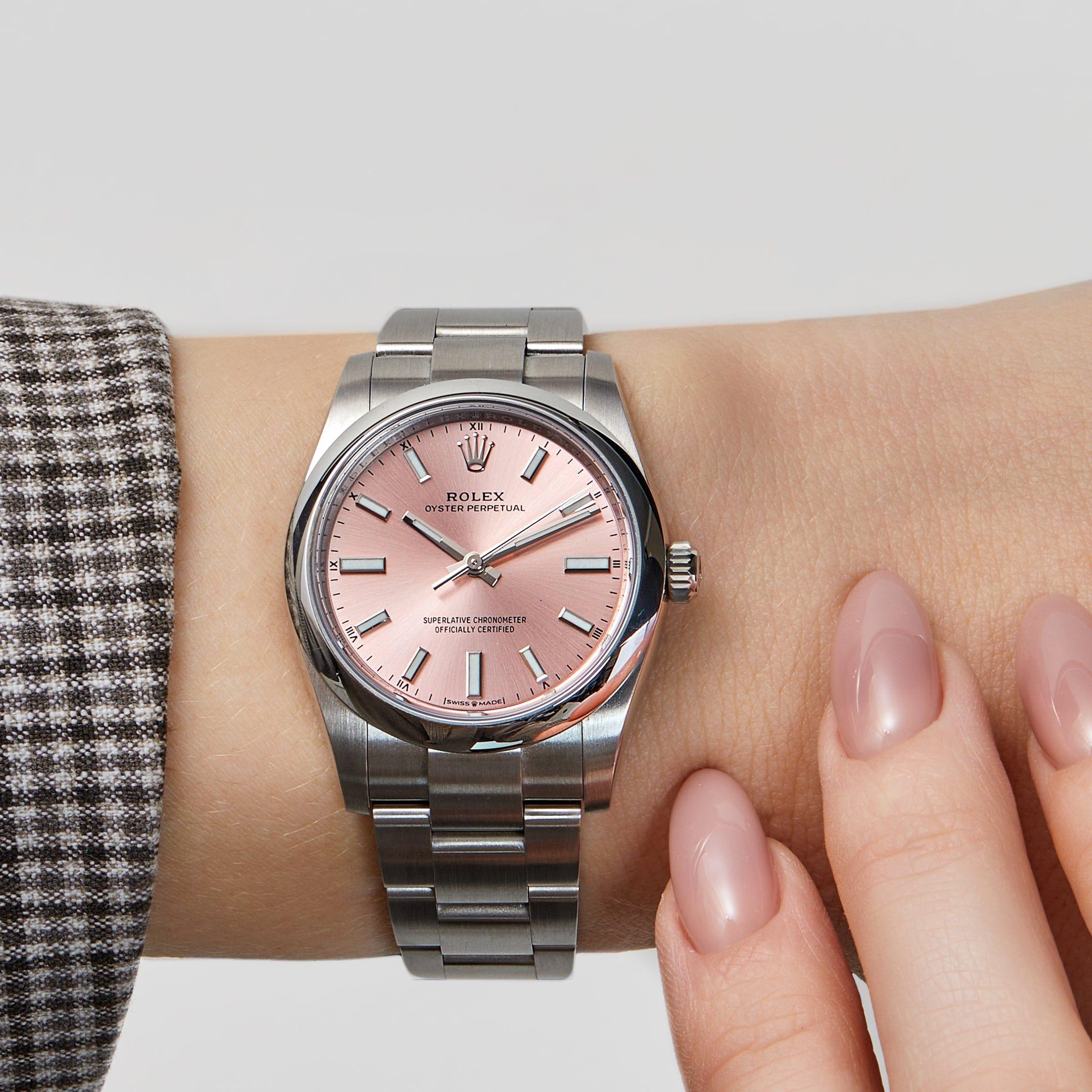 Jewels Aficionado offers this Rolex Oyster Perpetual 276200, a delicate yet enduring timepiece that combines classic design with a subtle touch of color. Encased in a 28mm stainless steel case with a polished smooth bezel, this model exudes
