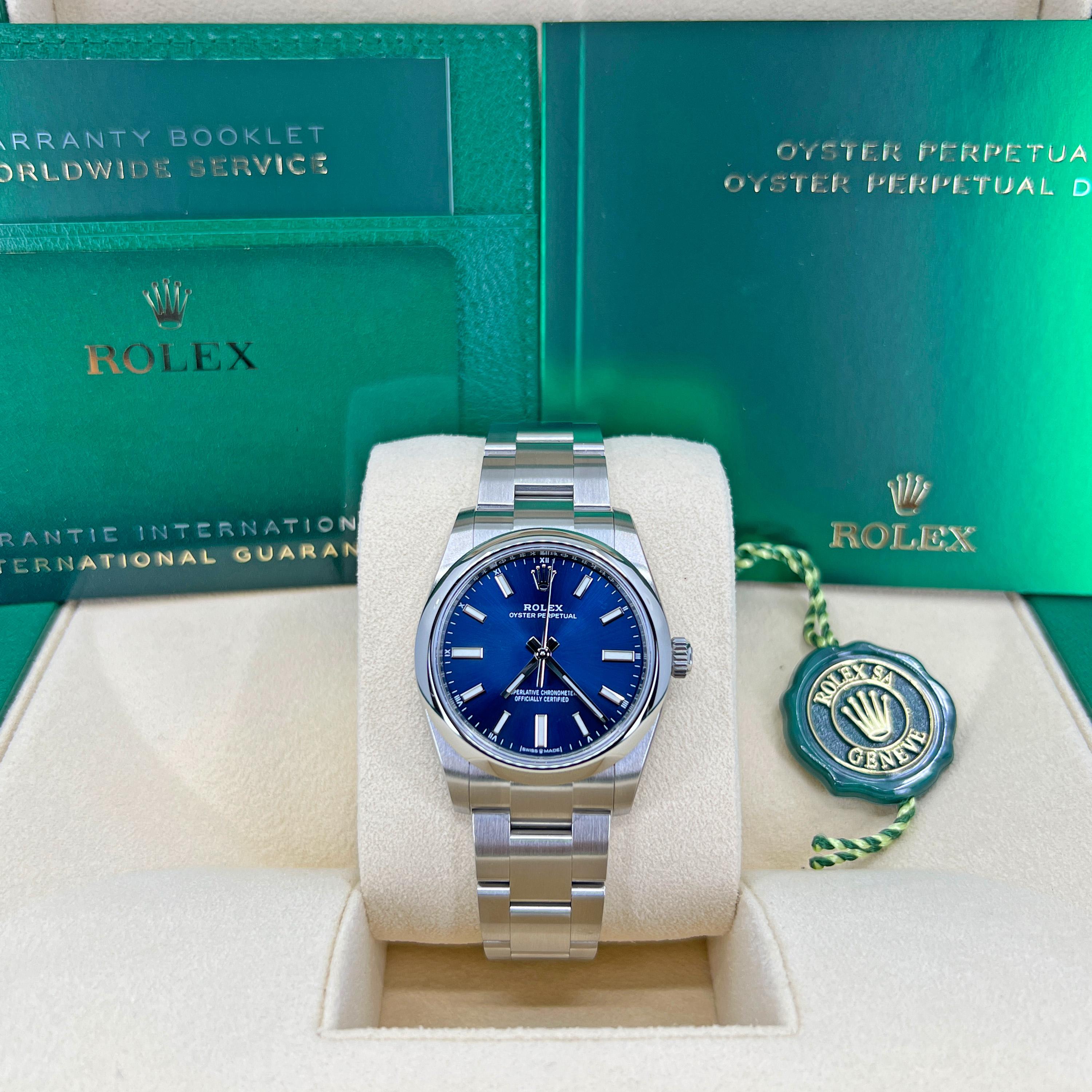 Rolex Oyster Perpetual, Brushed Stainless Steel case with polished finished sides 34mm watch. This model has a Bright blue dial with a highly legible Chromalight display with long-lasting blue luminescence with a fine sunray finish. Applied polished
