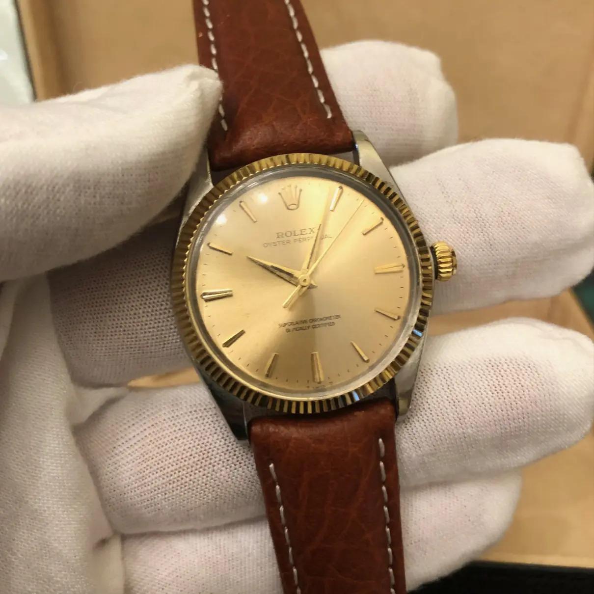 Rolex Oyster Perpetual 1005 two tone 14k yellow gold Men's 34 mm champagne dial watch. The Rolex movement is running and it's an official self-winding Rolex automatic 1560 movement.

This original genuine Rolex timepiece for Men features a 14k