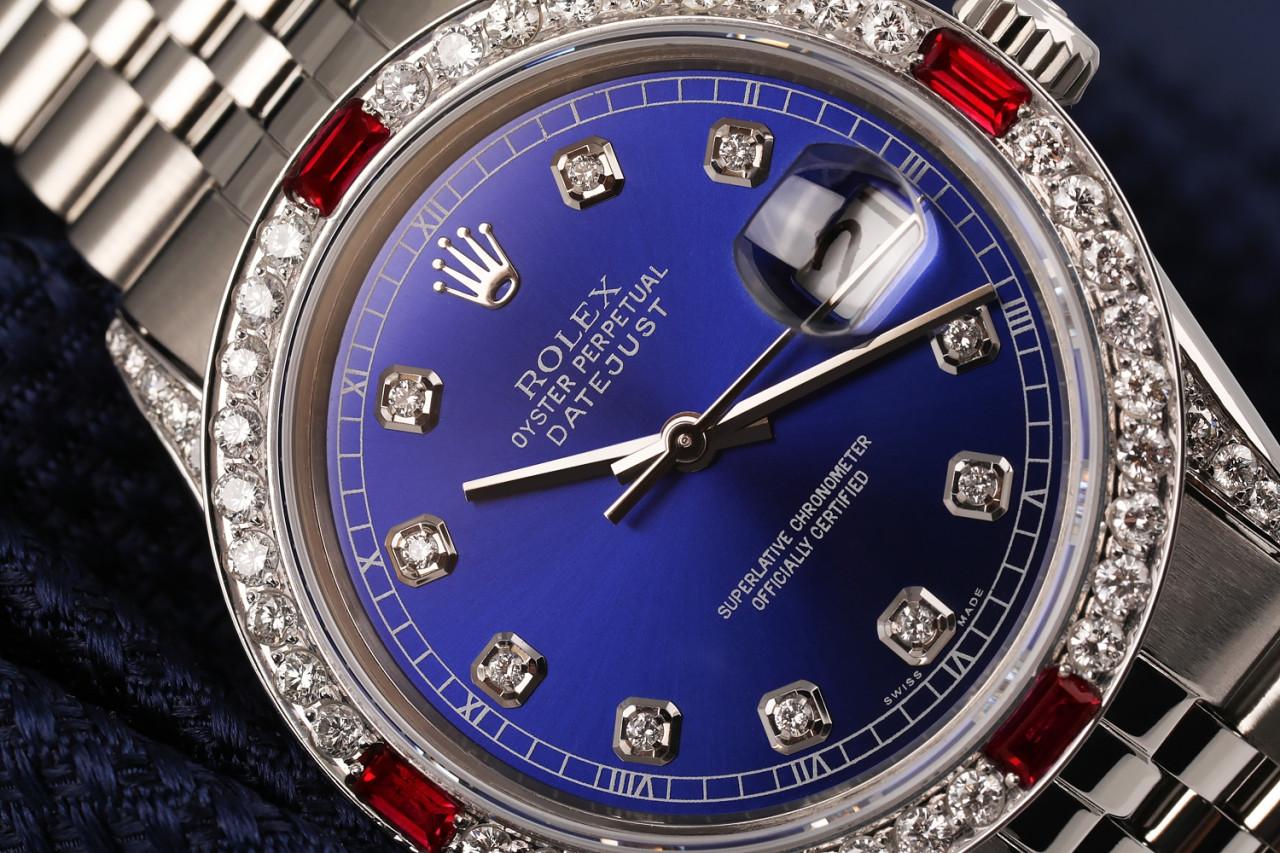 Rolex Oyster Perpetual 36mm Datejust Blue Diamond Face with Diamond & Ruby Bezel Jubilee Band 16014.
This watch is in like new condition. It has been polished, serviced and has no visible scratches or blemishes. All our watches come with a standard