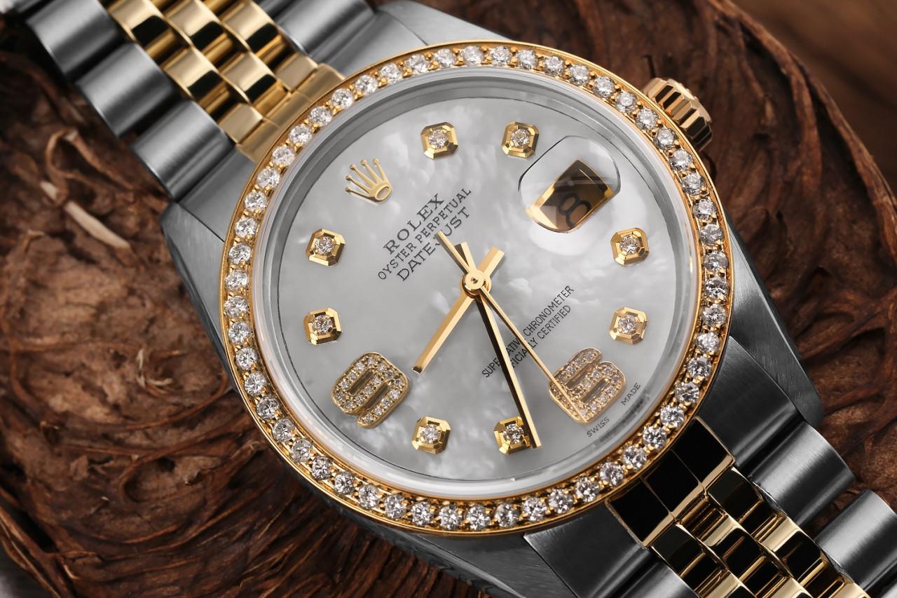 Rolex Oyster Perpetual 36mm Datejust 16013 Diamond Bezel White Mother Of Pearl Dial with Diamond 6 & 9 Numbers
This watch is in like new condition. It has been polished, serviced and has no visible scratches or blemishes. All our watches come with a