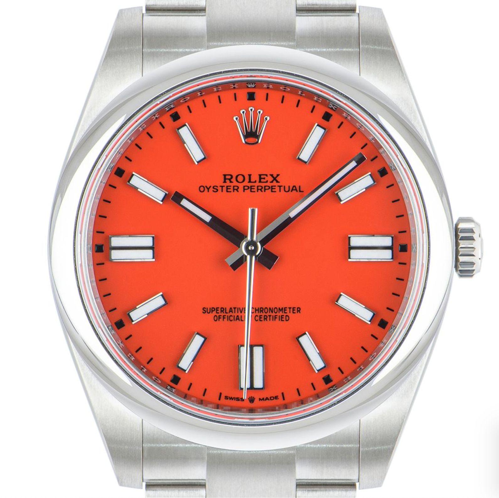An unworn 41mm Oyster Perpetual from Rolex in Oystersteel. Features a coral red dial and a smooth domed bezel. The Oyster bracelet comes with a folding Oysterclasp which is equipped with the Easylink 5mm comfort extension link. Fitted with a