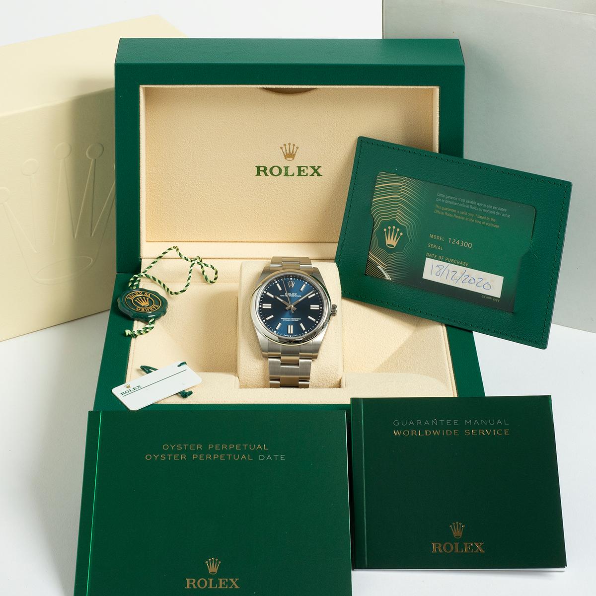 Our Rolex Oyster Perpetual with 41mm stainless steel case, reference 124300, features a blue dial and has been unworn (and with factory stickers intact) since it was purchased new in December 2020 , retailed by a recognised UK Rolex authorised