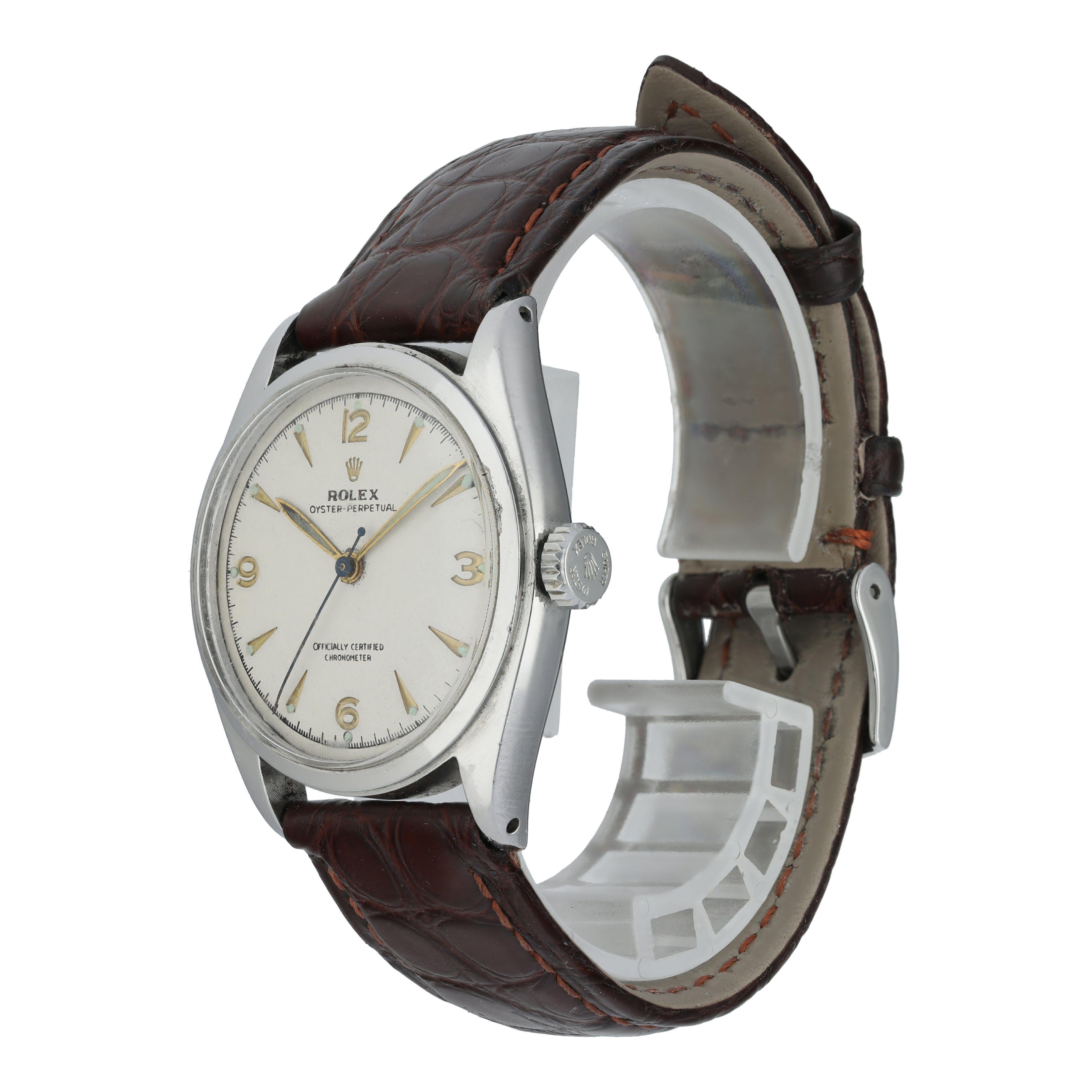 Rolex Oyster Perpetual 6084 men's Watch.
36mm stainless steel case with smooth bezel.
Offf-white patina dial with gold hands Arabic numeral hour markers.
Brown crocodile leather strap with original Rolex Buckle.
Will fit up to a 7.5-inch