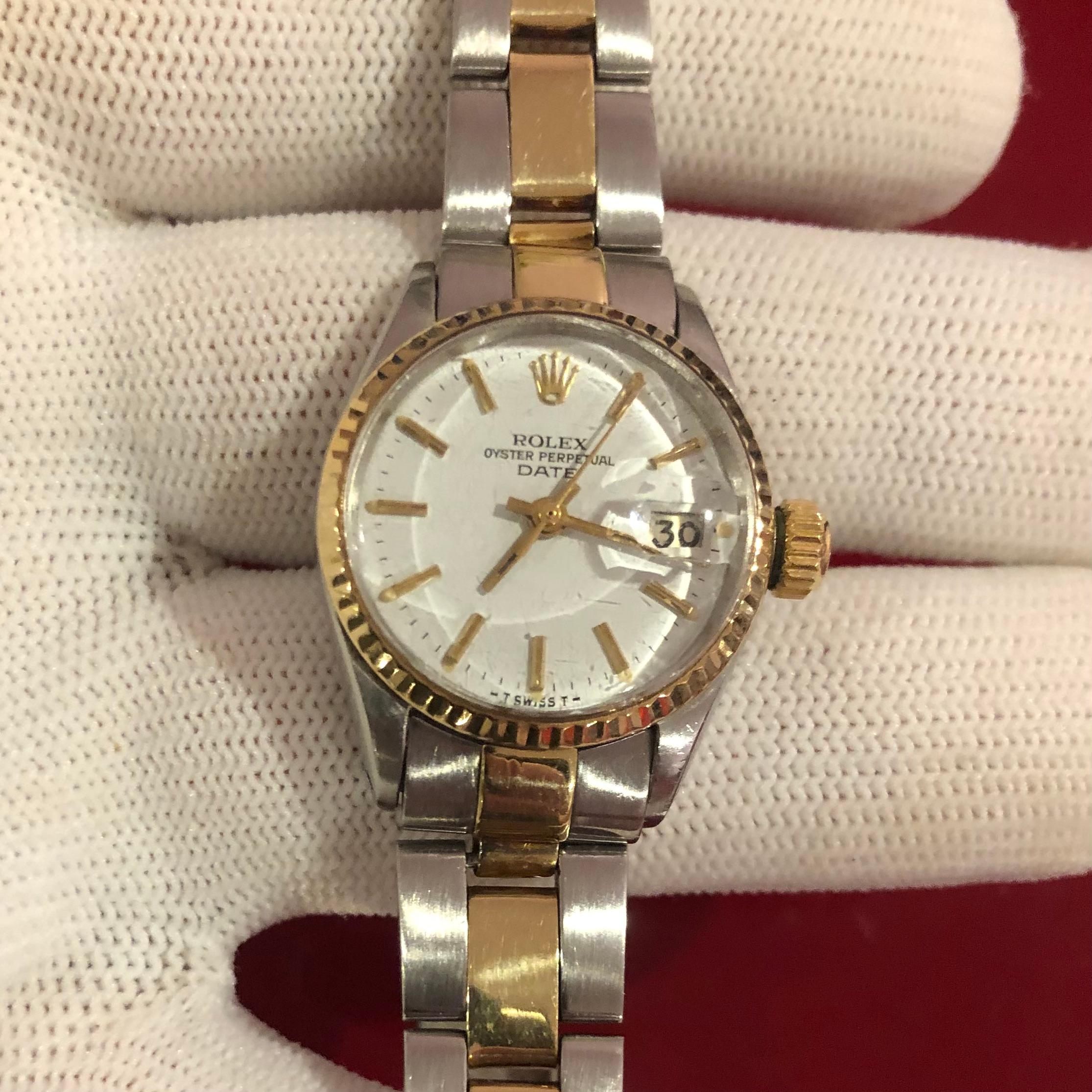 Rolex Oyster Perpetual 6517 two tone 14k Lady Date 26mm white dial ladies watch. The Rolex movement is running and an official self-winding Rolex automatic movement. 

This original genuine Rolex timepiece features a 14k yellow gold fluted bezel and