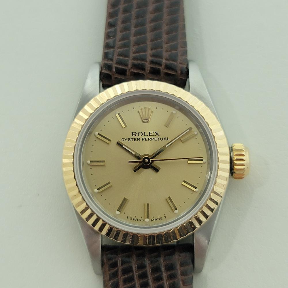 Classic luxury, Ladies Rolex 18k gold and stainless steel Oyster Perpetual automatic, c.1986, in excellent working condition. Verified authentic by a master watchmaker. Gorgeous Rolex gold dial with applied baton index hour markers, gilt minute and