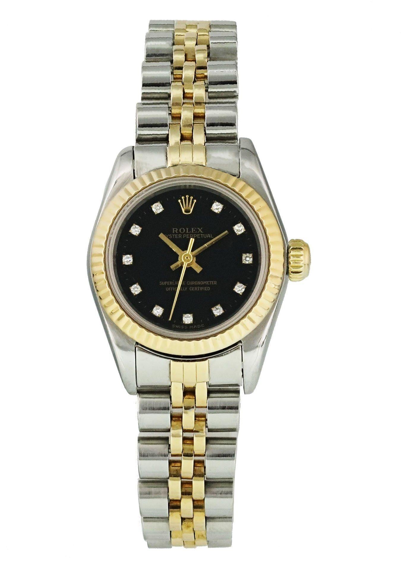 Rolex Oyster Perpetual 67193 Ladies Watch. 
24mm Stainless Steel case. 
Yellow Gold Stationary bezel. 
Black dial with gold hands and factory set diamond hour markers. 
Minute markers on the outer dial. 
Stainless Steel Bracelet with Fold Over