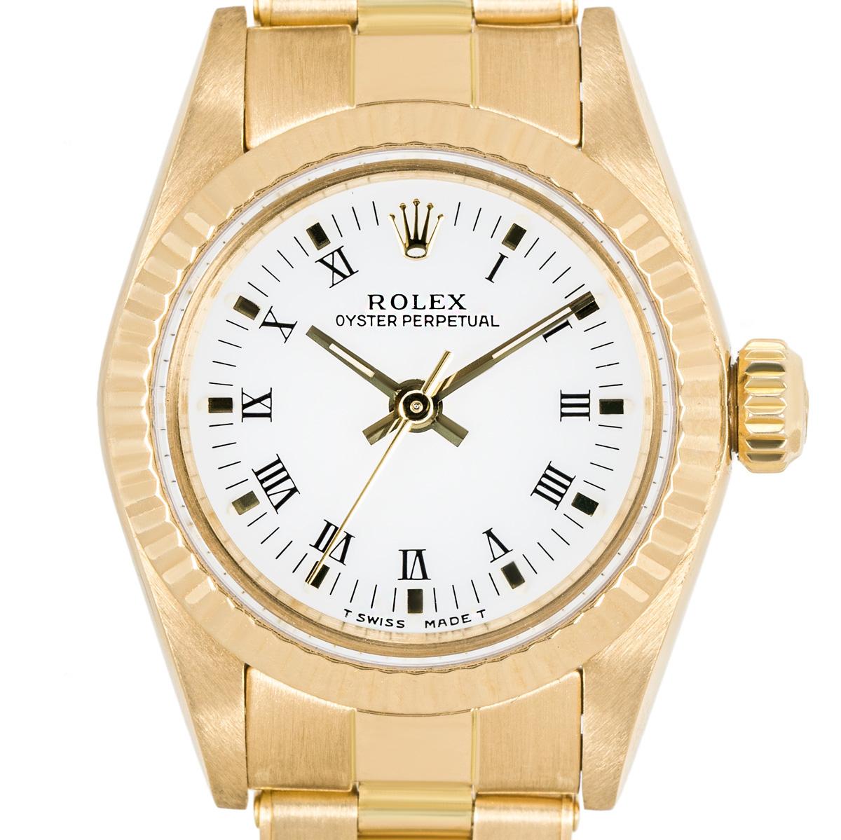 A Rolex 26mm ladies Oyster Perpetual in yellow gold. Featuring a white dial with roman numerals and a yellow gold fluted bezel. Fitted with a sapphire crystal and powered by a self-winding automatic movement. The watch is equipped with a yellow gold
