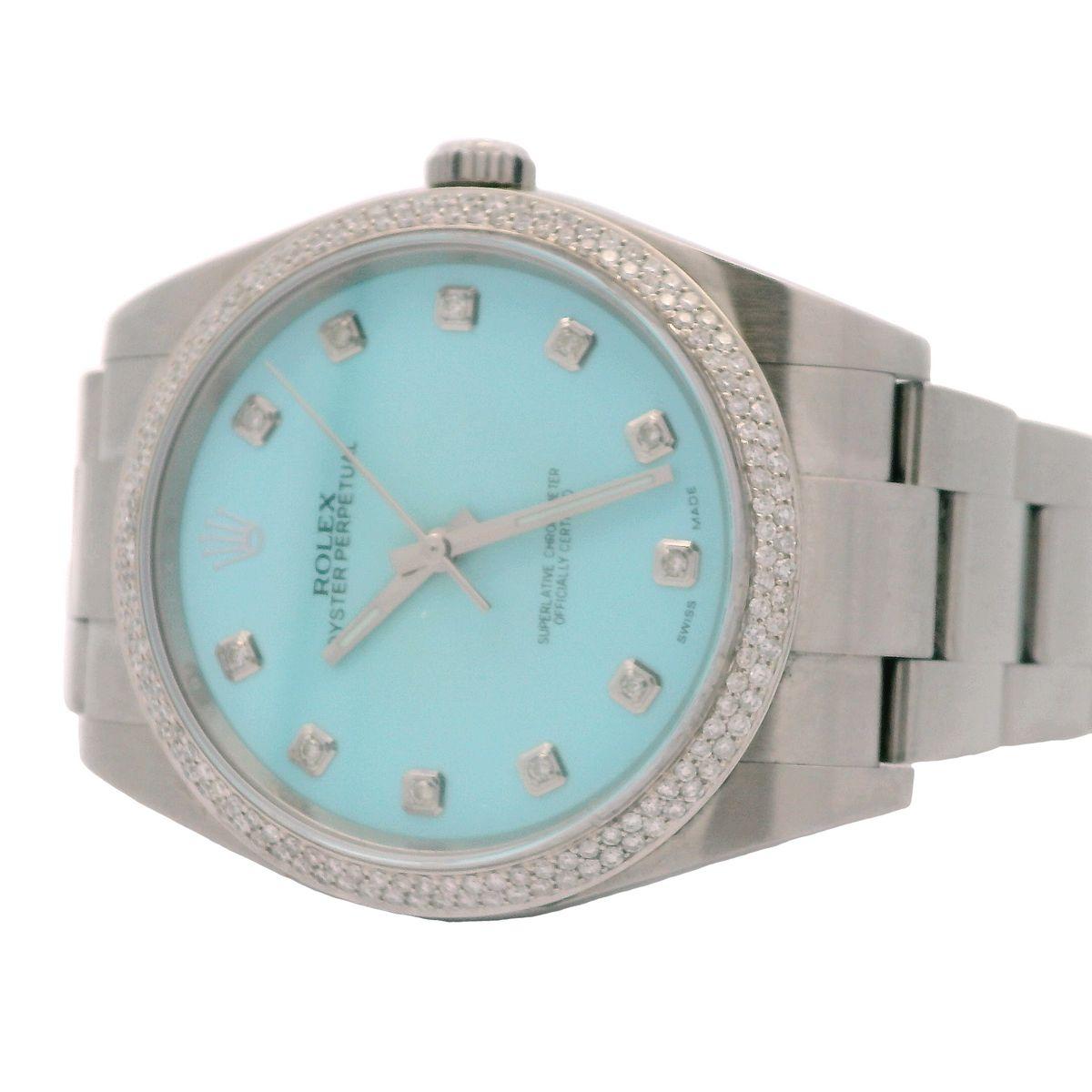 Rolex Oyster Perpetual stainless steel customized aftermarket turquoise colored diamond dial and diamond bezel offered by Alex & Co. This stunning timepiece is pre-owned in excellent condition and features a custom Tiffany style dial with diamond