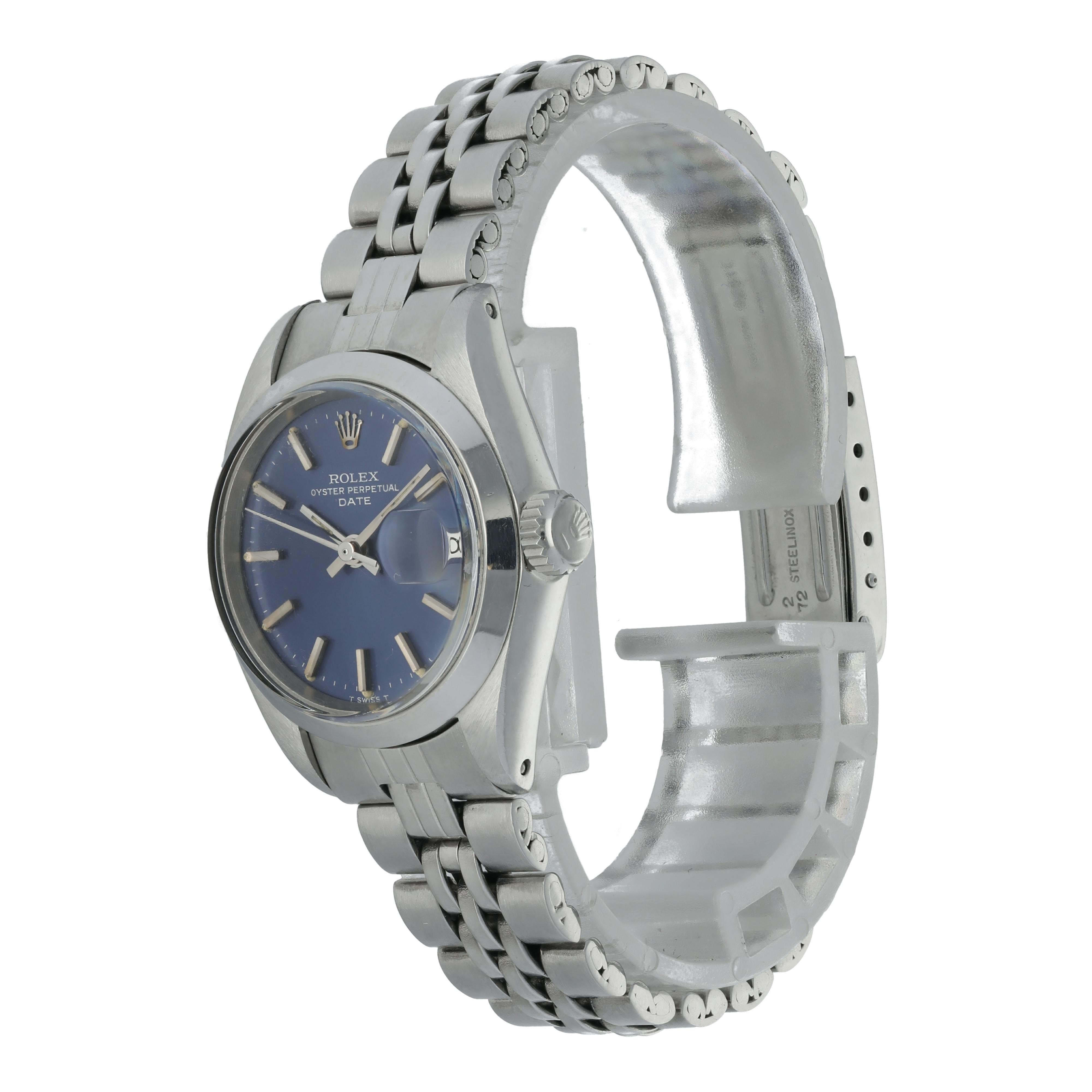 Rolex Oyster Perpetual Date 6916 Ladies Watch.
26mm Stainless Steel case. 
Stainless Steel Stationary bezel. 
Blue dial with steel hands and index hour markers. 
Minute markers on the outer dial. 
Date display at the 3 o'clock position. 
Stainless