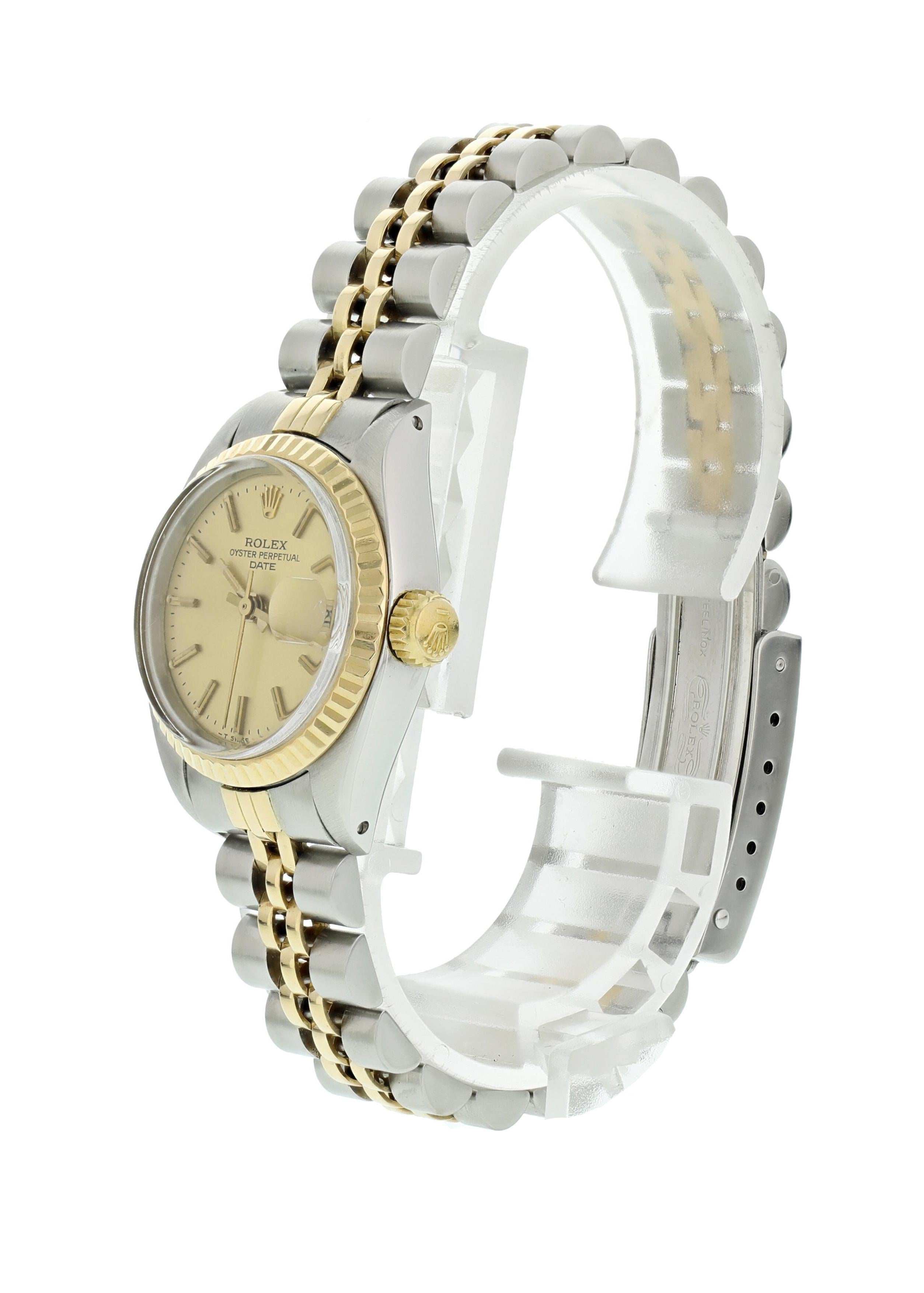 Rolex Oyster Perpetual Date 6917 Ladies Watch. 26mm stainless steel case with an 18k yellow gold fluted bezel. Champagne dial with yellow gold hands and markers. 18k yellow gold and stainless steel Jubilee band with a stainless steel fold-over clasp