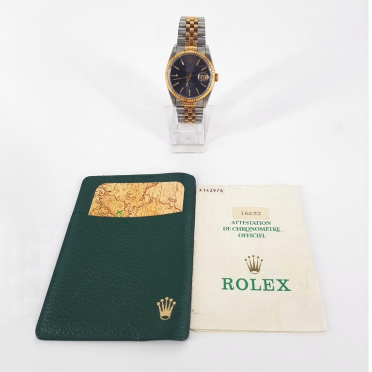 Rolex Oyster Perpetual Date Just Watch- Automatic in good condition. 
Model Number: 16233 & Serial Number: X143978
Stainless Steel & Gold Case (36mm diameter). Blue dial with gold hands. Jubilee style strap (56mm). Includes Papers
