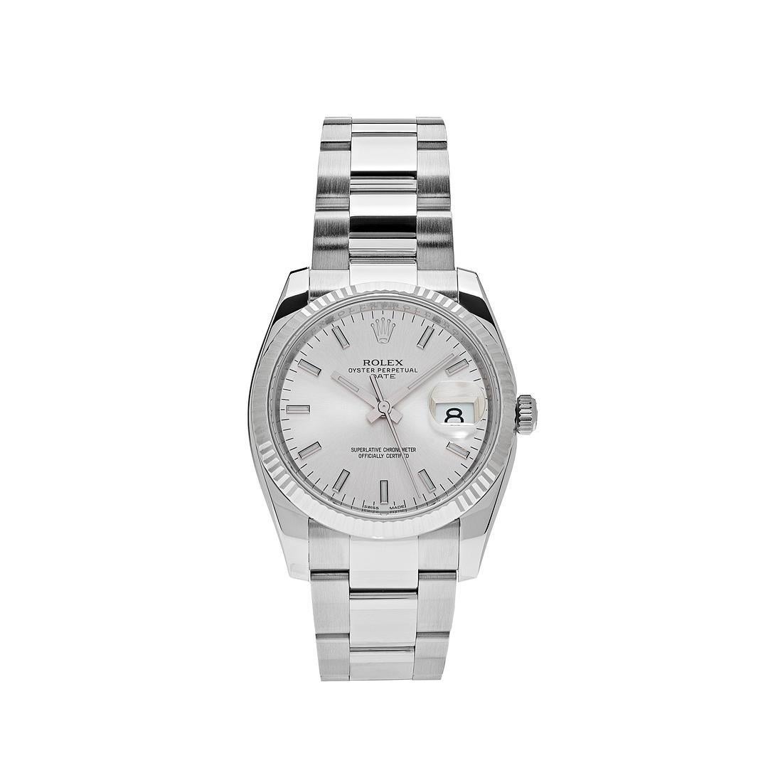 This vintage Rolex Oyster Perpetual date is crafted in a 34mm stainless steel case with a white gold fluted bezel. The silver dial features stick markers and a date display. The watch comes on an Oystersteel bracelet.

Reference Number	