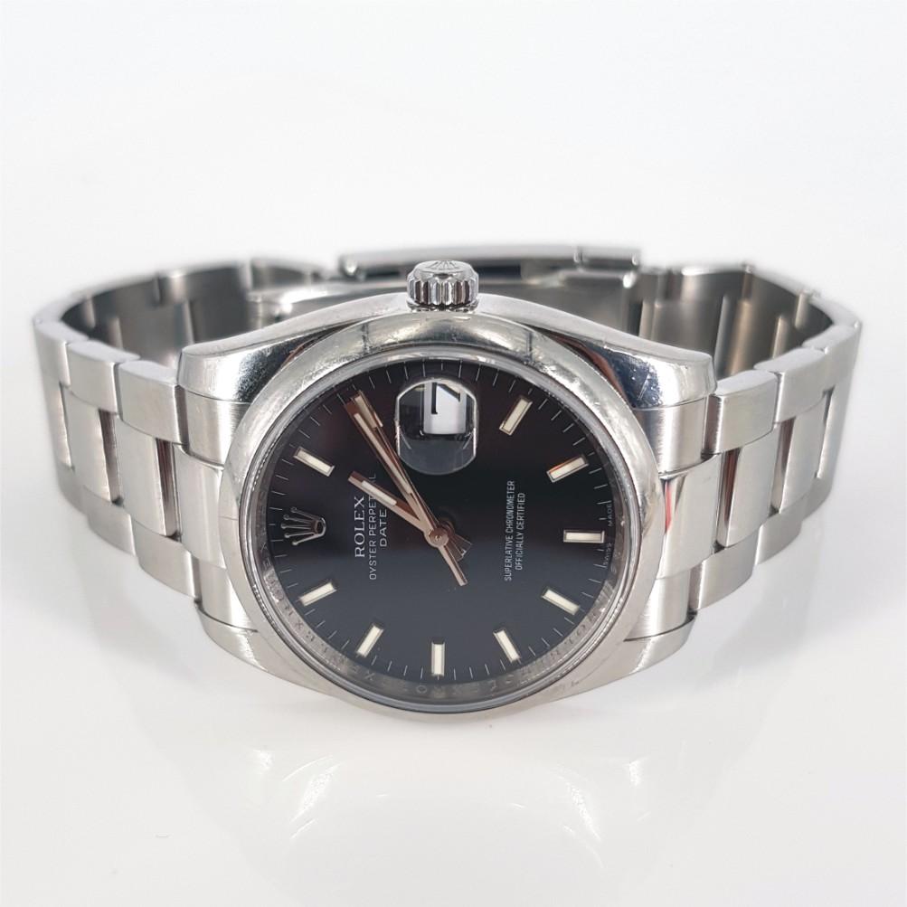 Rolex Oyster Perpetual Date Watch - Automatic in Very Good condition. 
Model Number: 115 200 & Serial Number: M278262 
Year: 2007 -2008
Stainless Steel Case (33mm). Black Dial with Steel Hands. Stainless Steel Strap (58mm)
